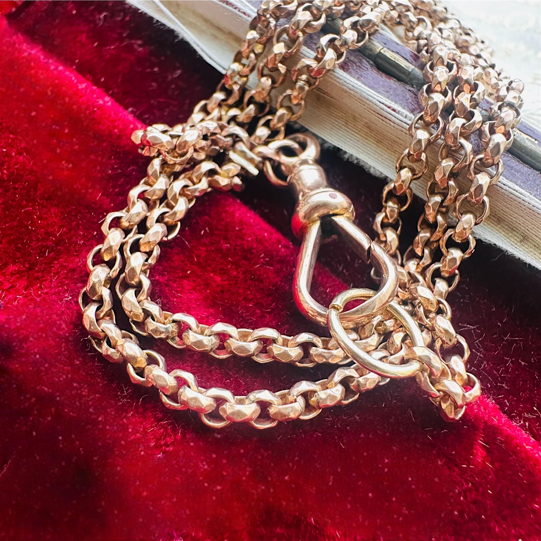Rose Gold Faceted Belcher Chain with Dog Clip Clasp displayed on an antique box.