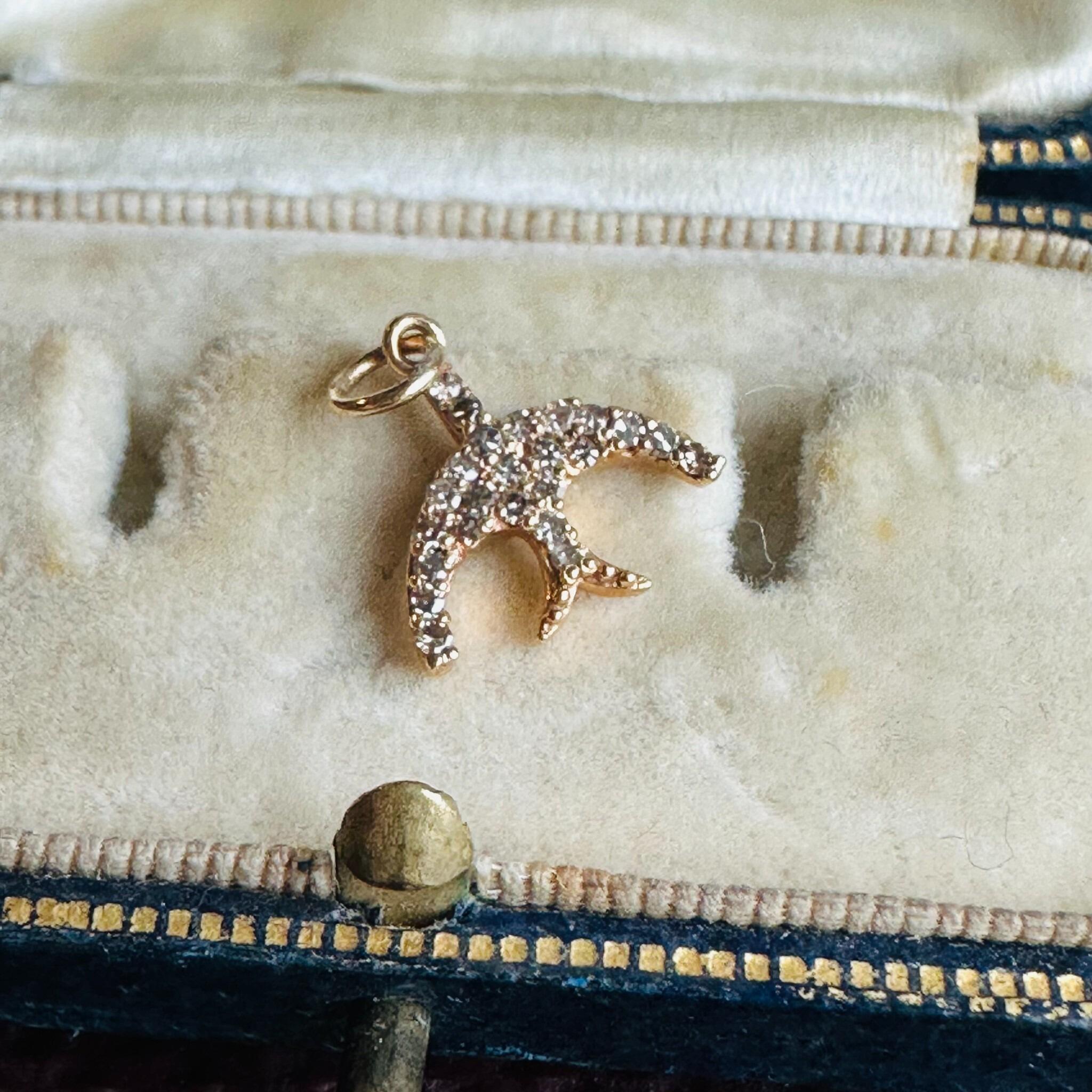 14ct Rose Gold & Diamond Swallow Charm Pendant, displayed on antique box