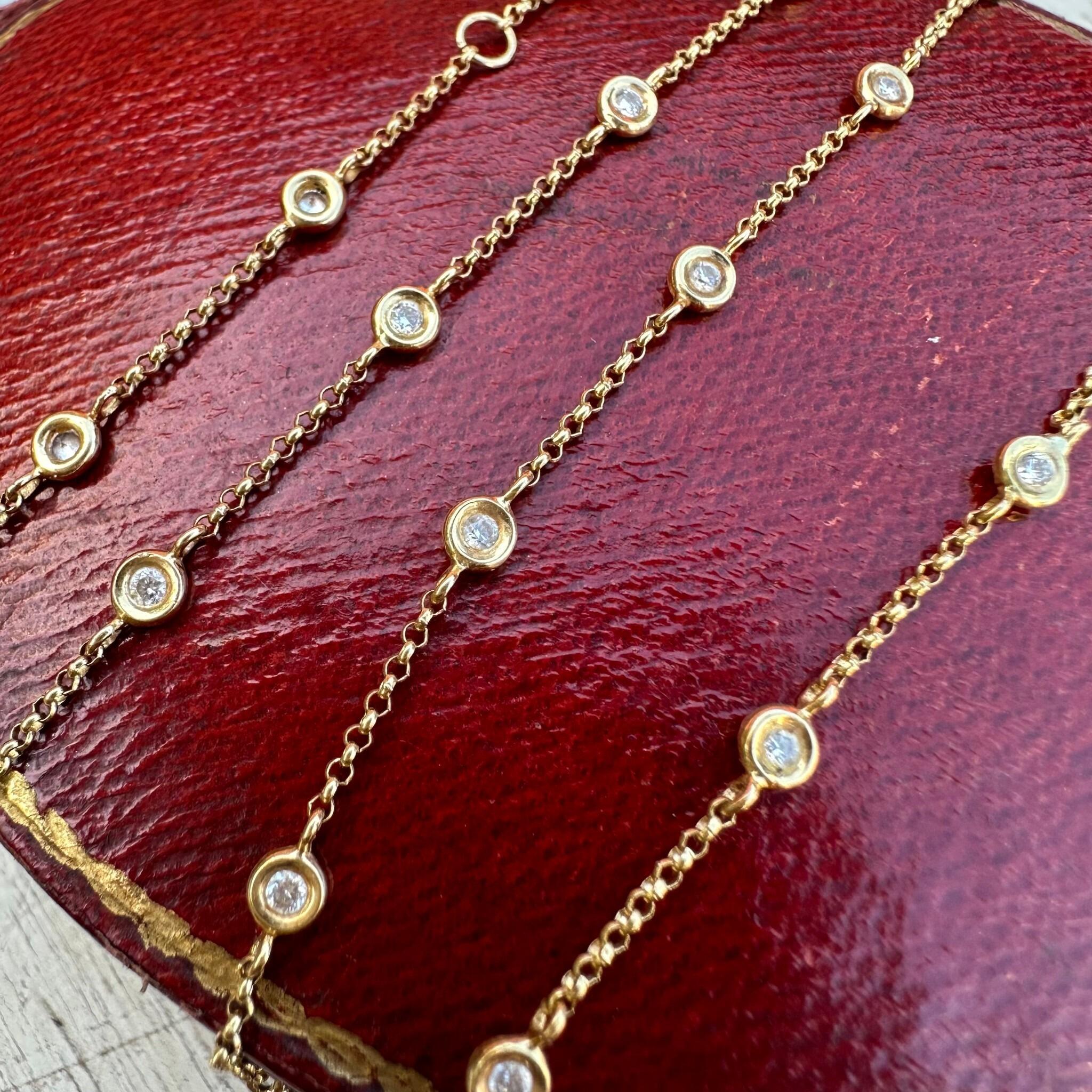 18K Gold Diamonds by the Yard Necklace Inspired by Tiffanys displayed on red antique box with grey background