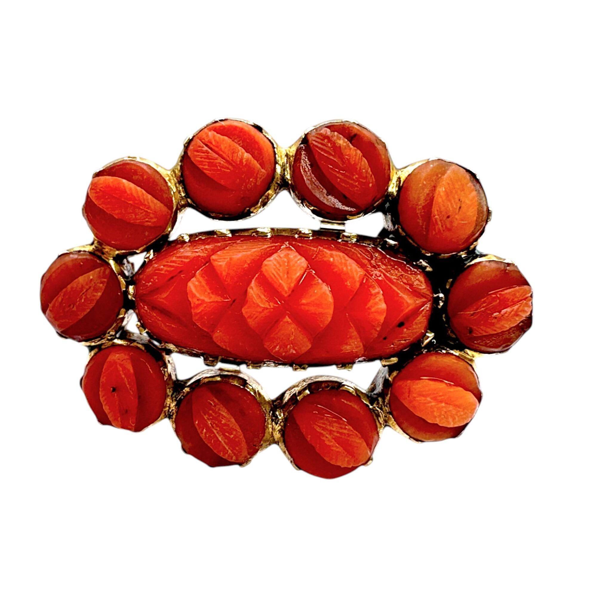 Georgian hand carved natural coral fichu brooch on white background.