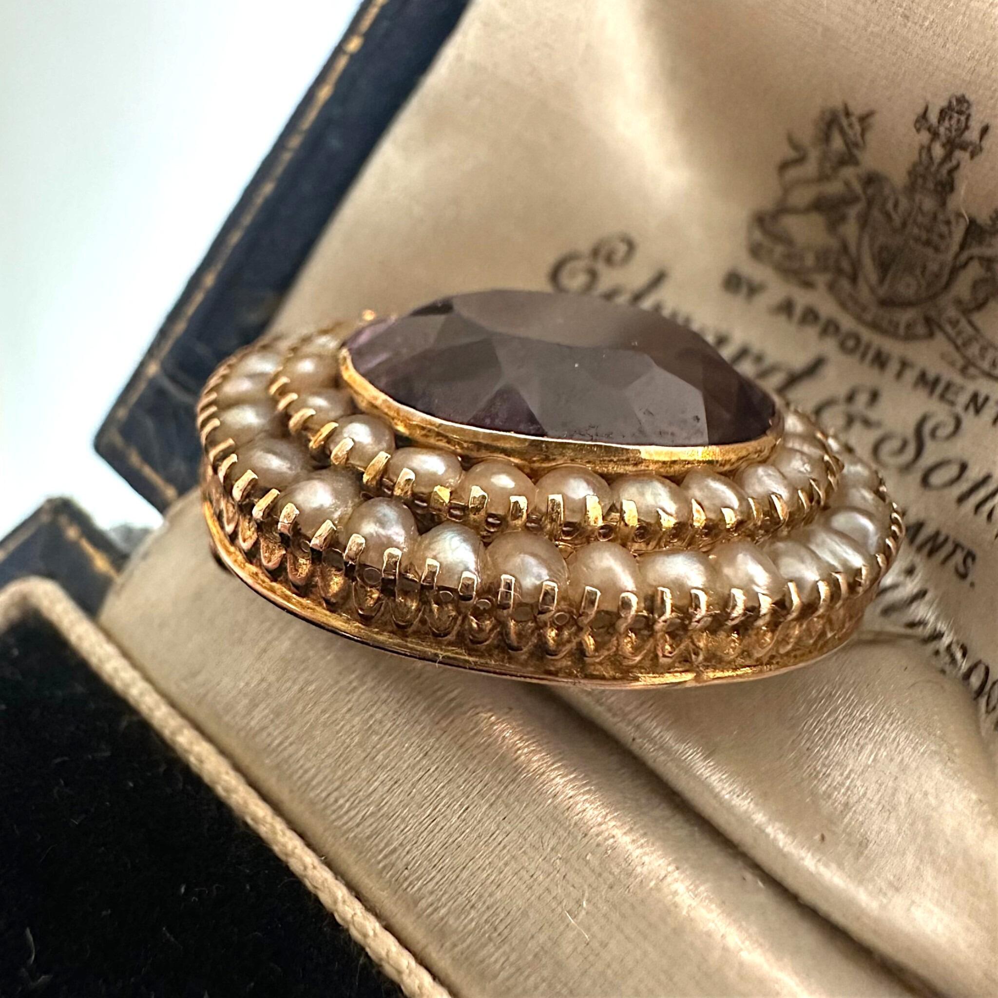 side profile of Antique Victorian Gold Rose de France Amethyst & Seed Pearl Brooch displayed on antique box