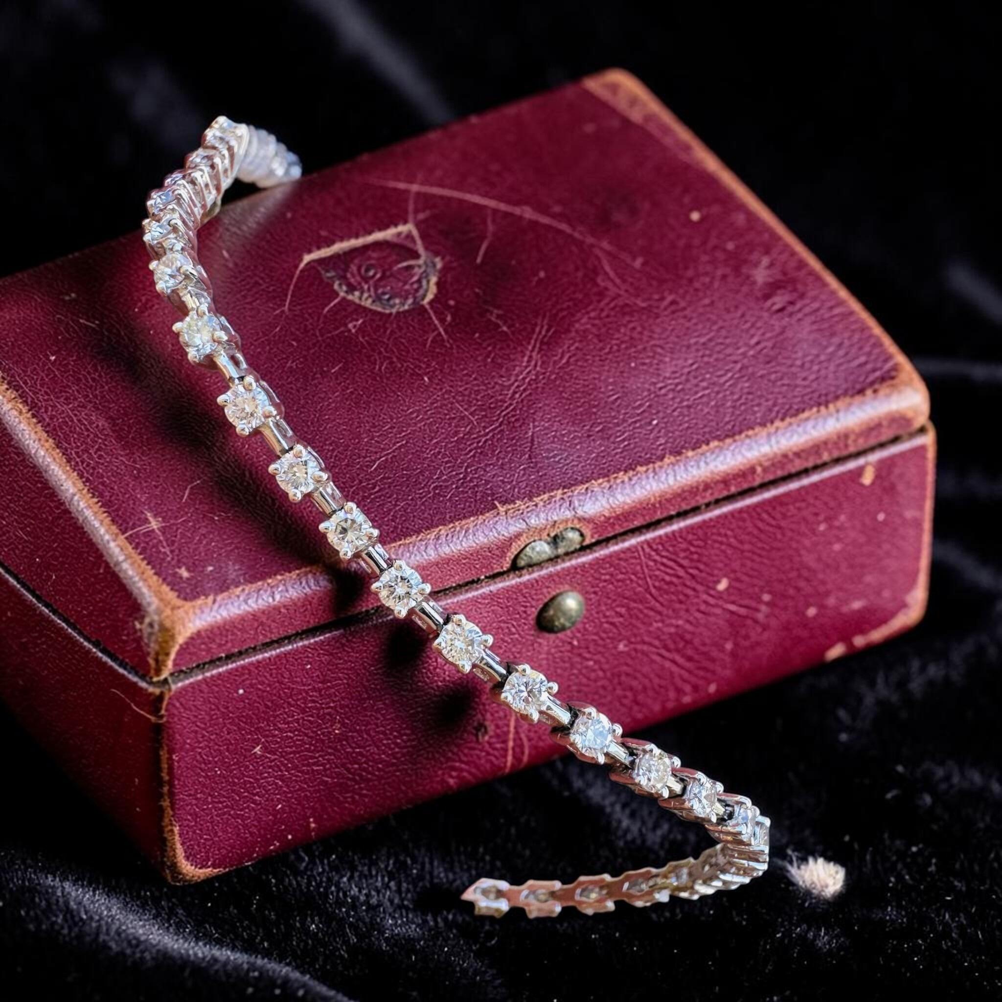 18K White Gold Diamond Tennis Bracelet displayed on red antique box, with black background