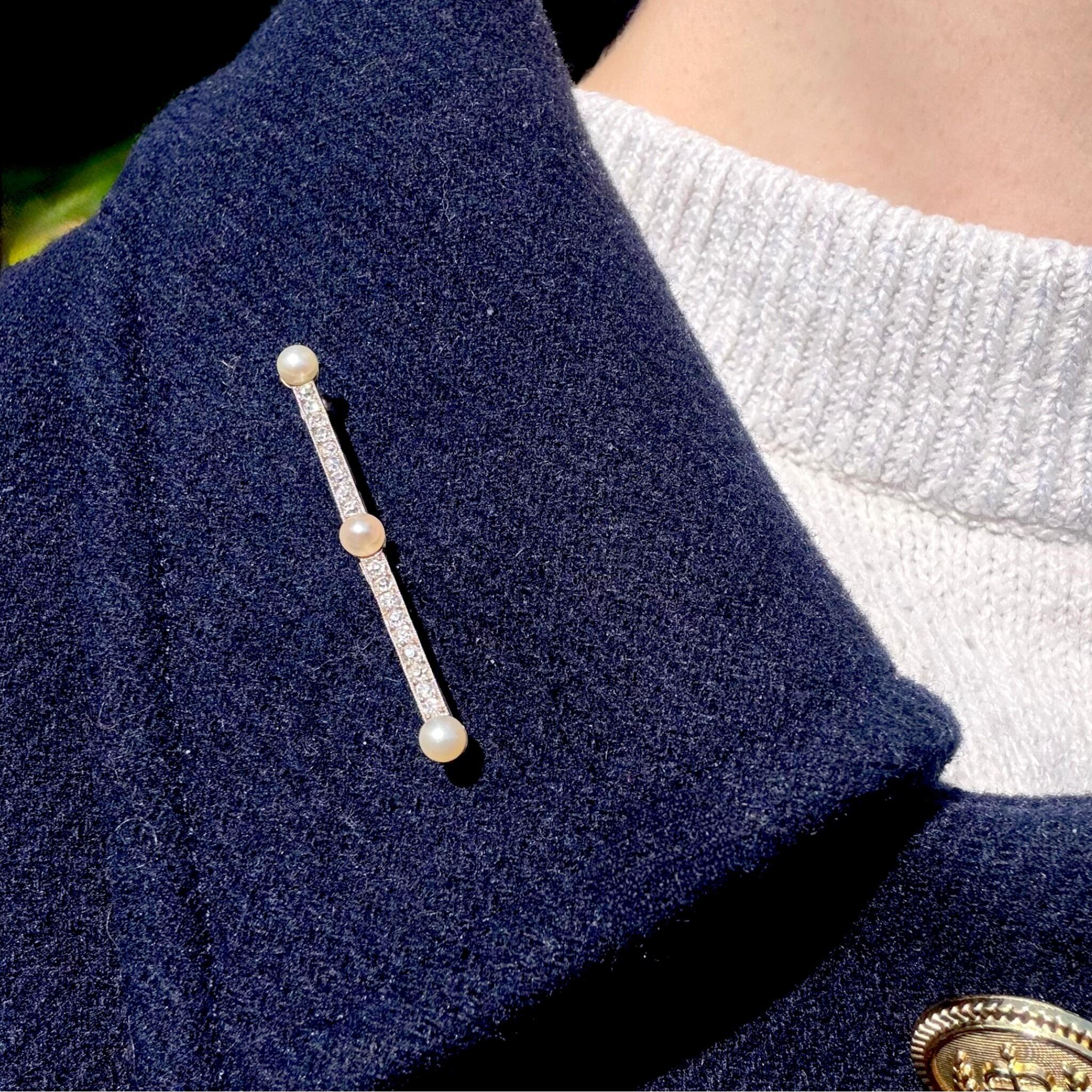 Antique Edwardian Platinum Diamond & Pearl Bar Brooch displayed on models jacket