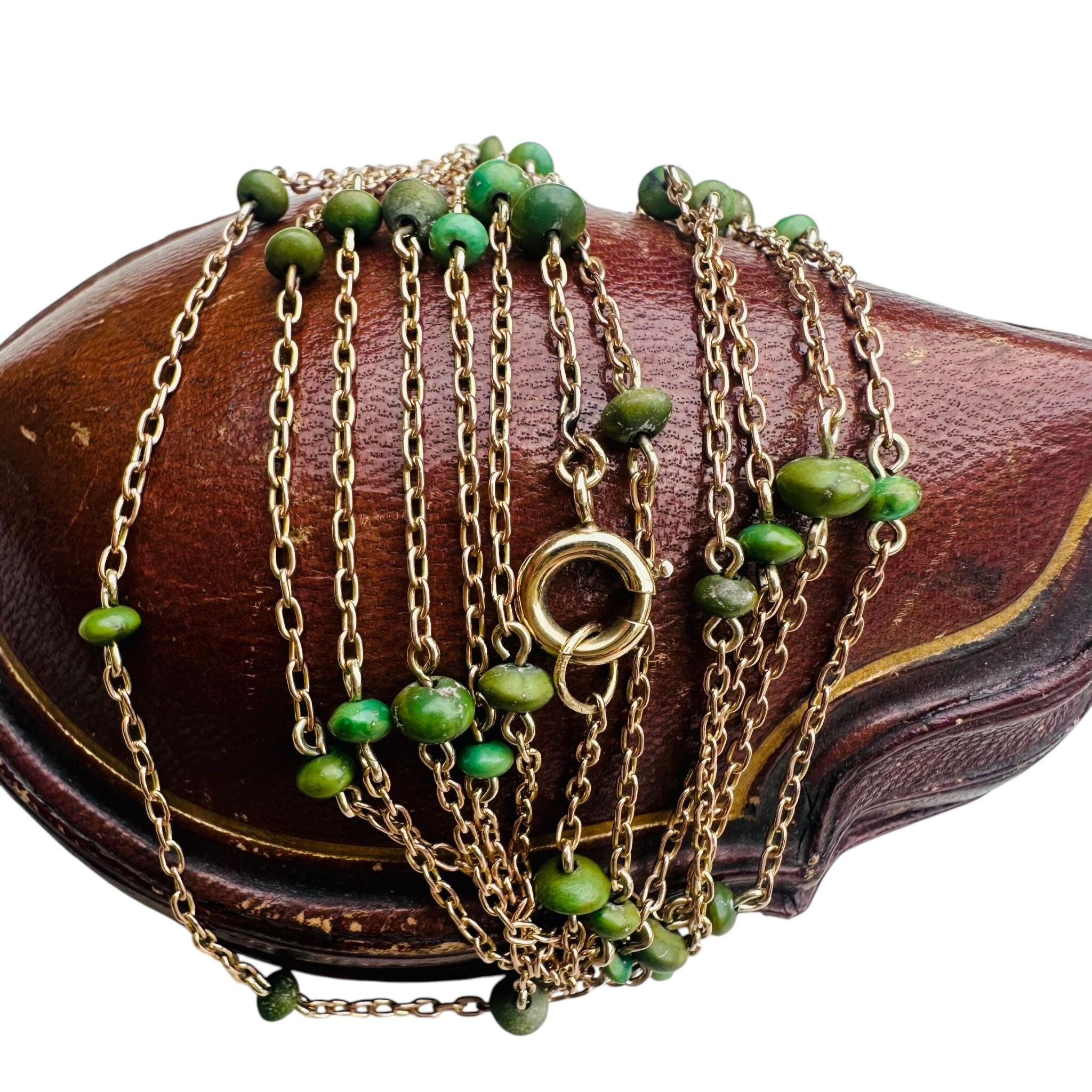 side view of Antique Edwardian 9ct Rose Gold Turquoise Bead Guard Chain displayed on antique box with white background