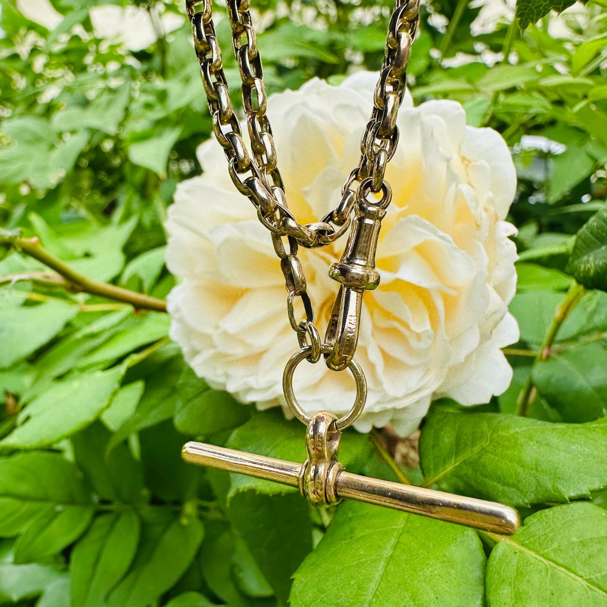 Close-up of a Victorian 9ct gold bike link chain with dog clip & t-bar fittings.
