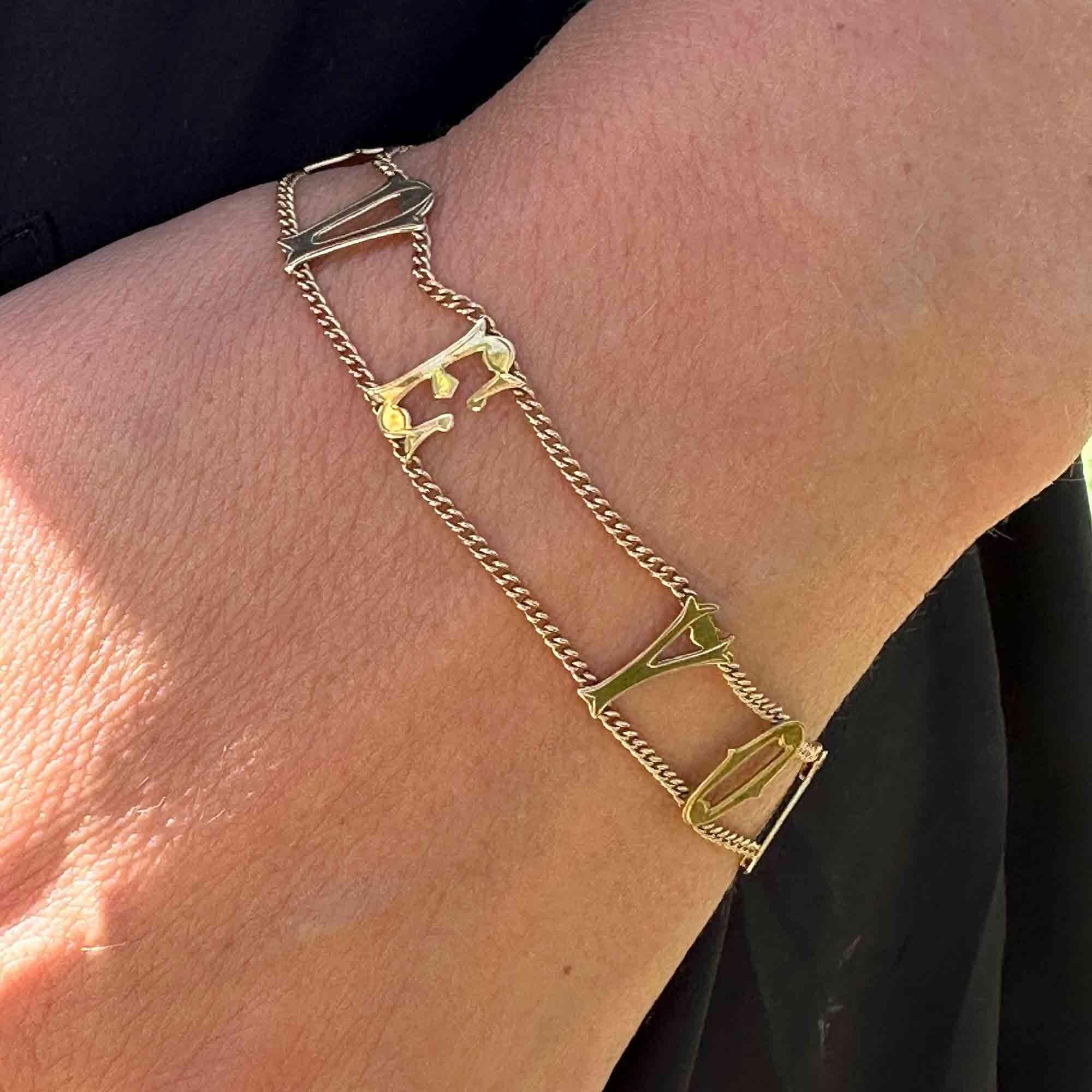 Vintage 9ct gold bracelet with "I Love You" links, on models wrist.