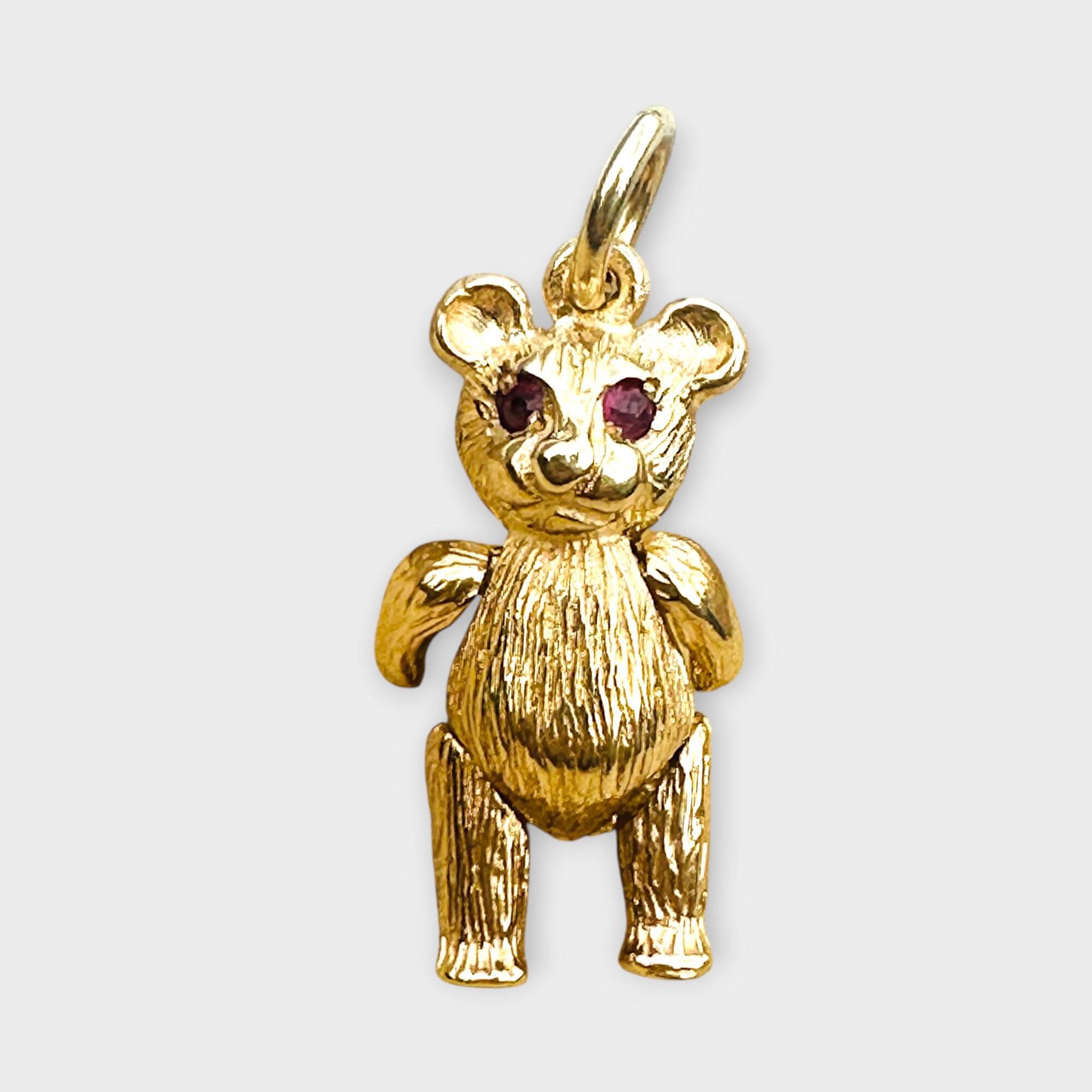 Vintage 9ct Gold Teddy Bear Pendant: Ruby Eyes, Articulated London Charm, grey background.