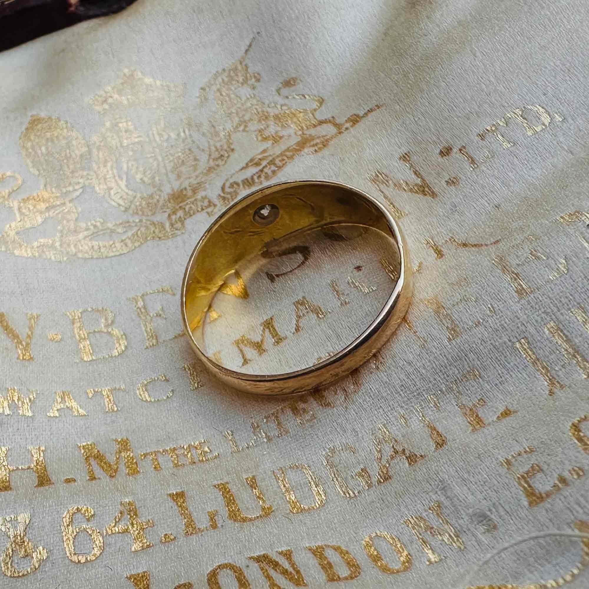 side view of 18ct Gold & Diamond Star Set Gypsy Ring, displayed on antique box