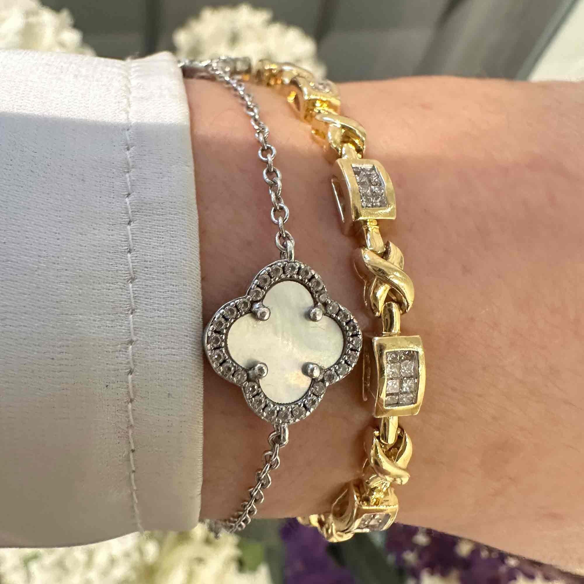 14k Gold Princess Cut Diamond Tennis Bracelet worn on models wrist in garden.