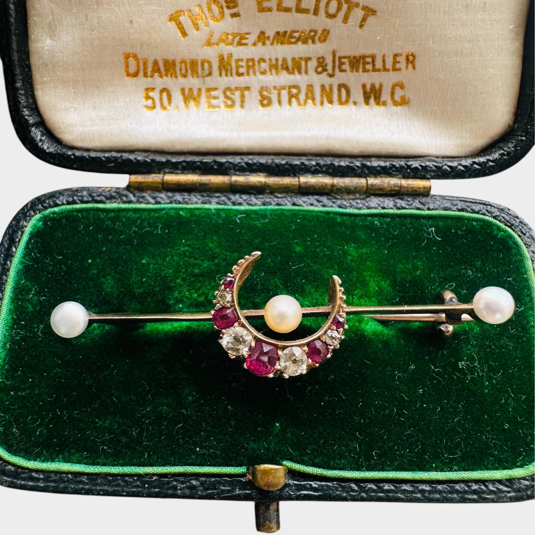 15ct Gold Diamond, Ruby & Pearl Crescent Moon Brooch displayed in green velvet antique box