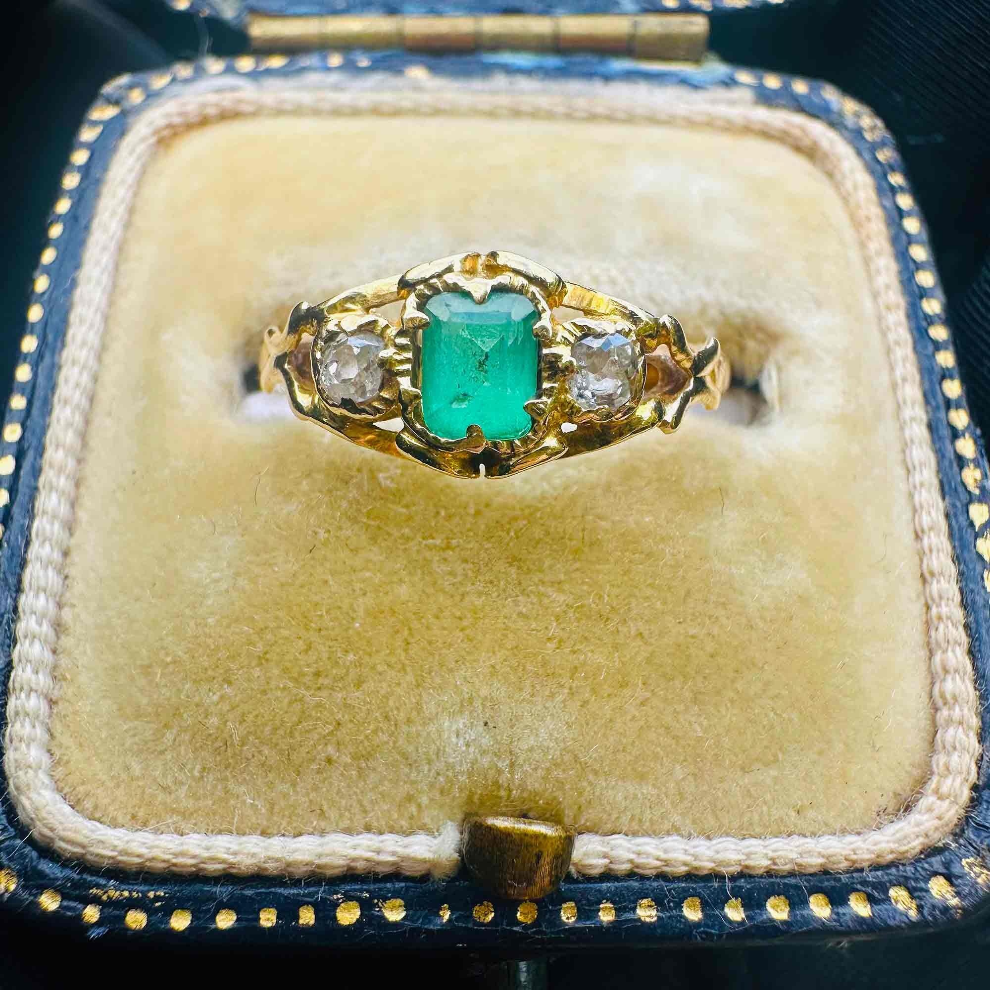 Emerald & Diamond Three Stone Victorian Ring displayed on antique box