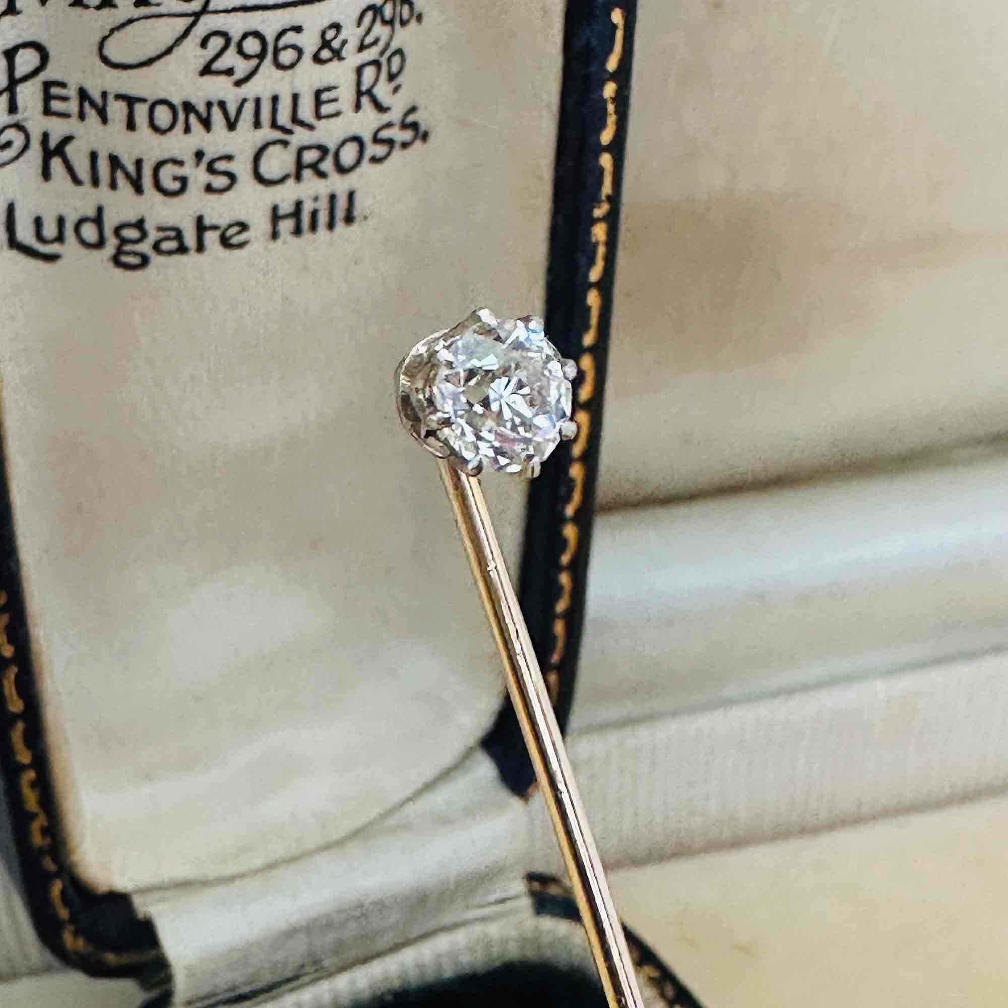 side profile of Edwardian 0.48ct Old European Cut Diamond Stick Pin & Original Box laying on other antique boxes