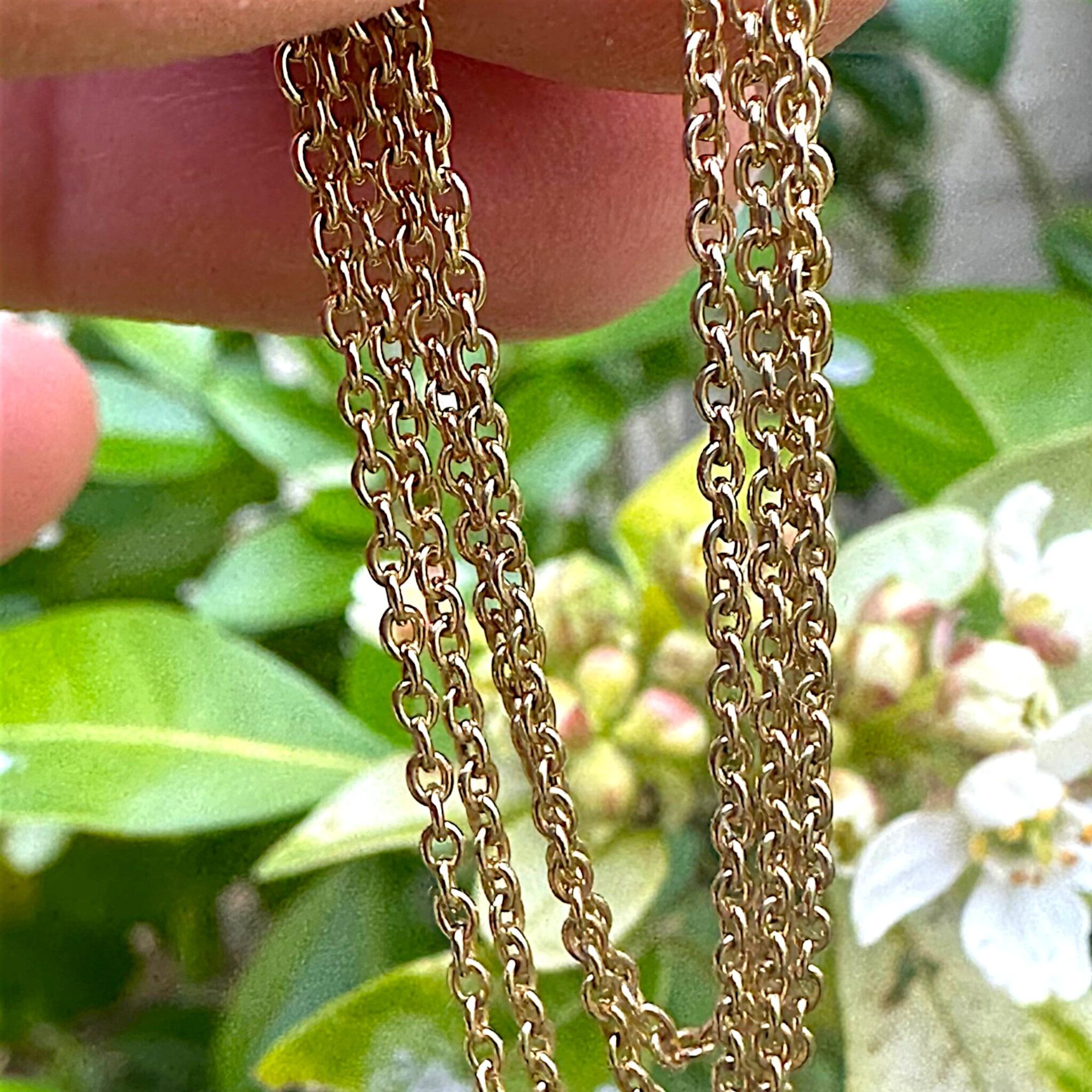 Antique 20 inch Gold Rolo Link Chain held in hand with garden background