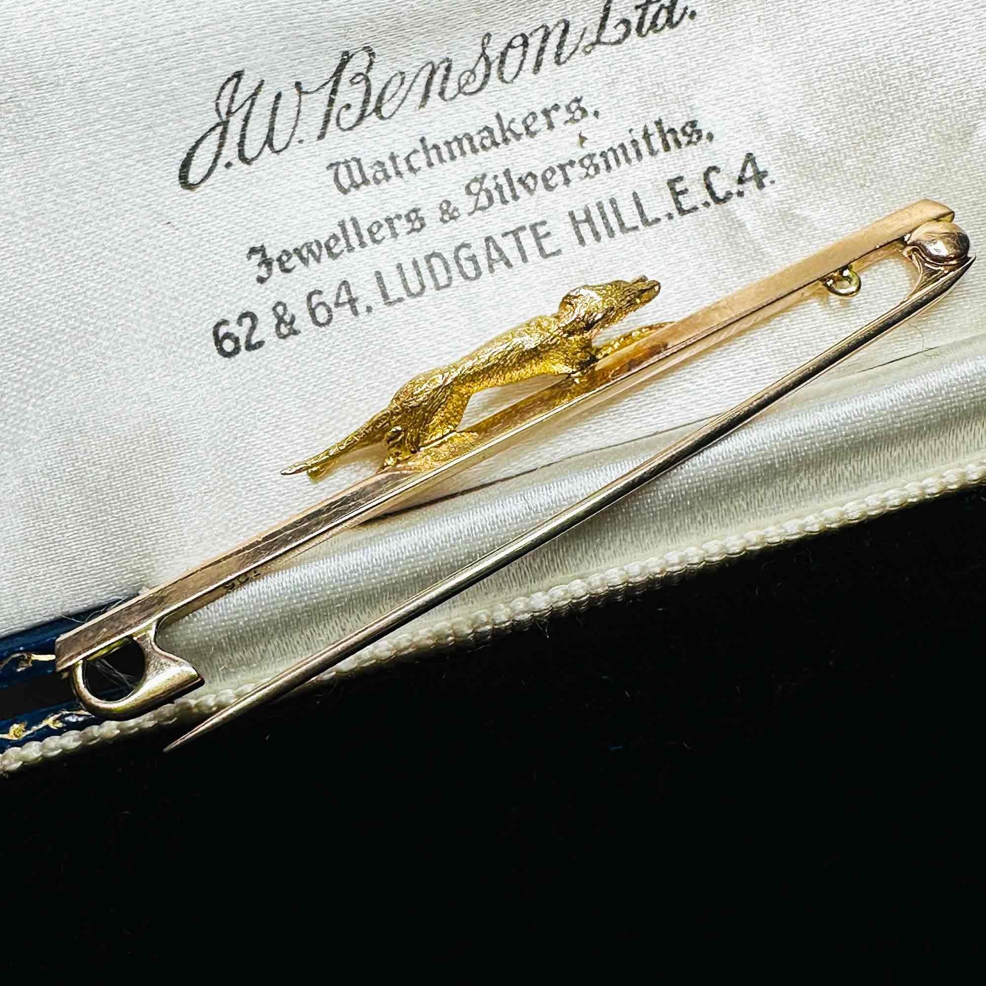side profile of Greyhound 9k Gold Dog Pin with Ruby Eye & Original J W Benson Blue Leather Box