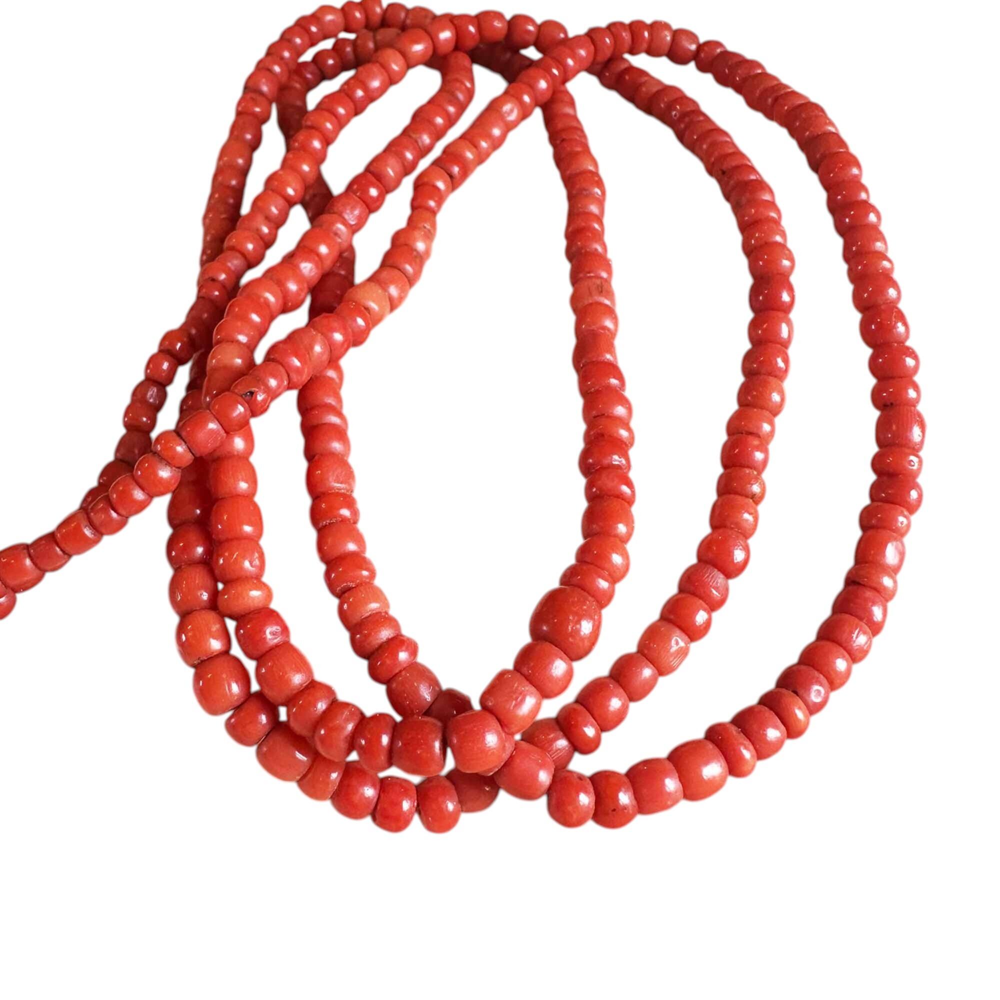 antique coral beaded necklace with white background