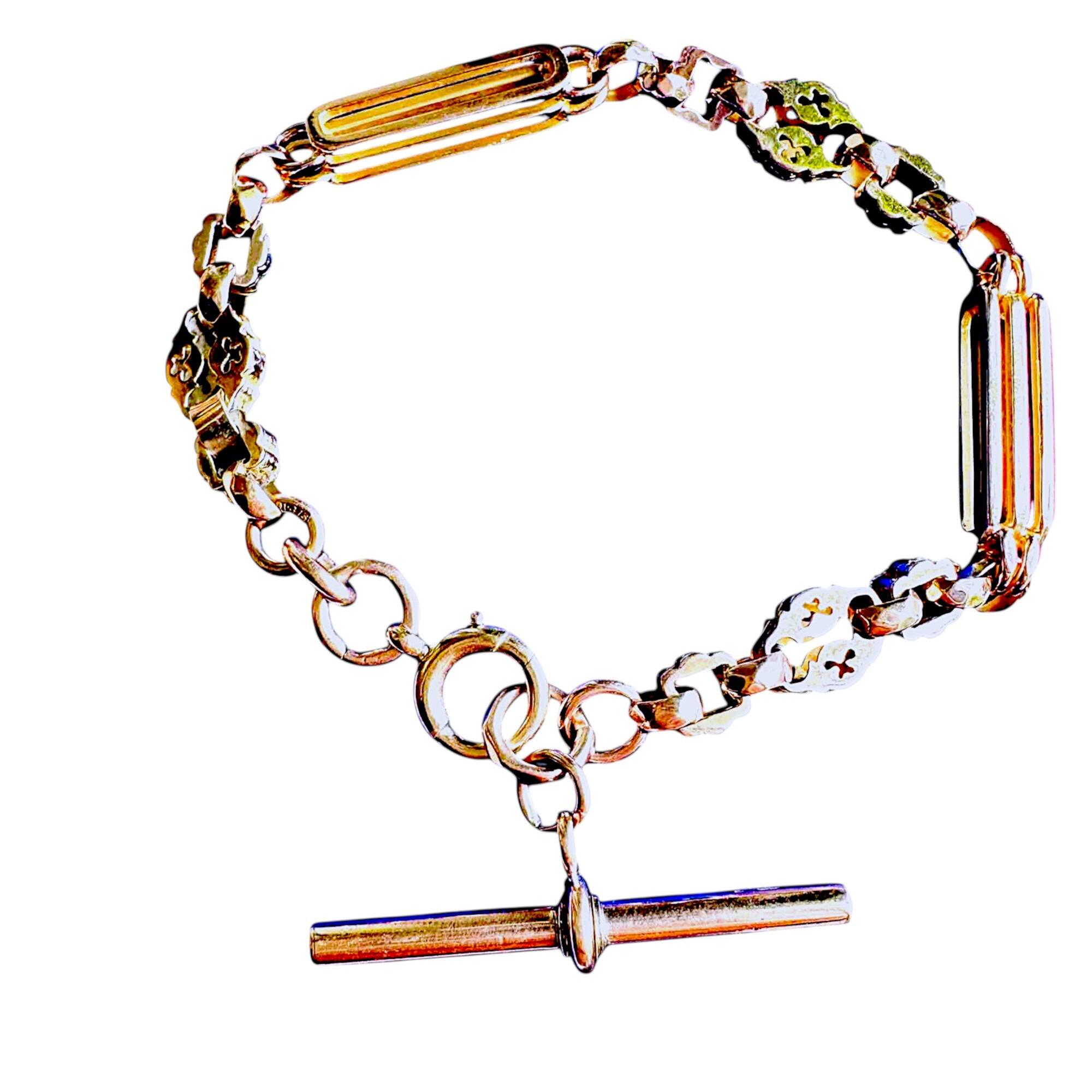 Victorian 9k rose gold trombone link bracelet with star bar and faceted belcher chain, displayed on grey background