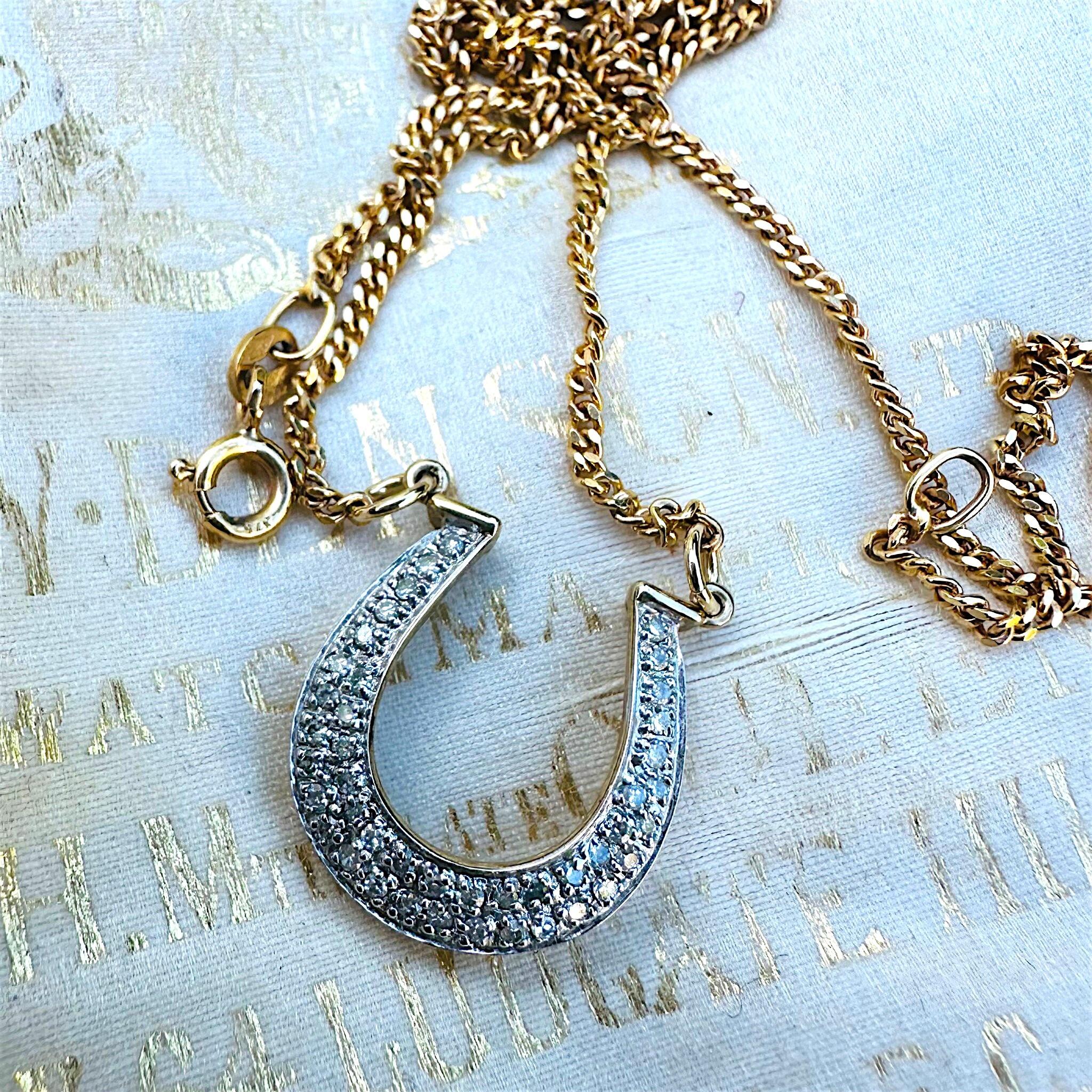 Vintage Diamond Horseshoe Necklace displayed on antique box