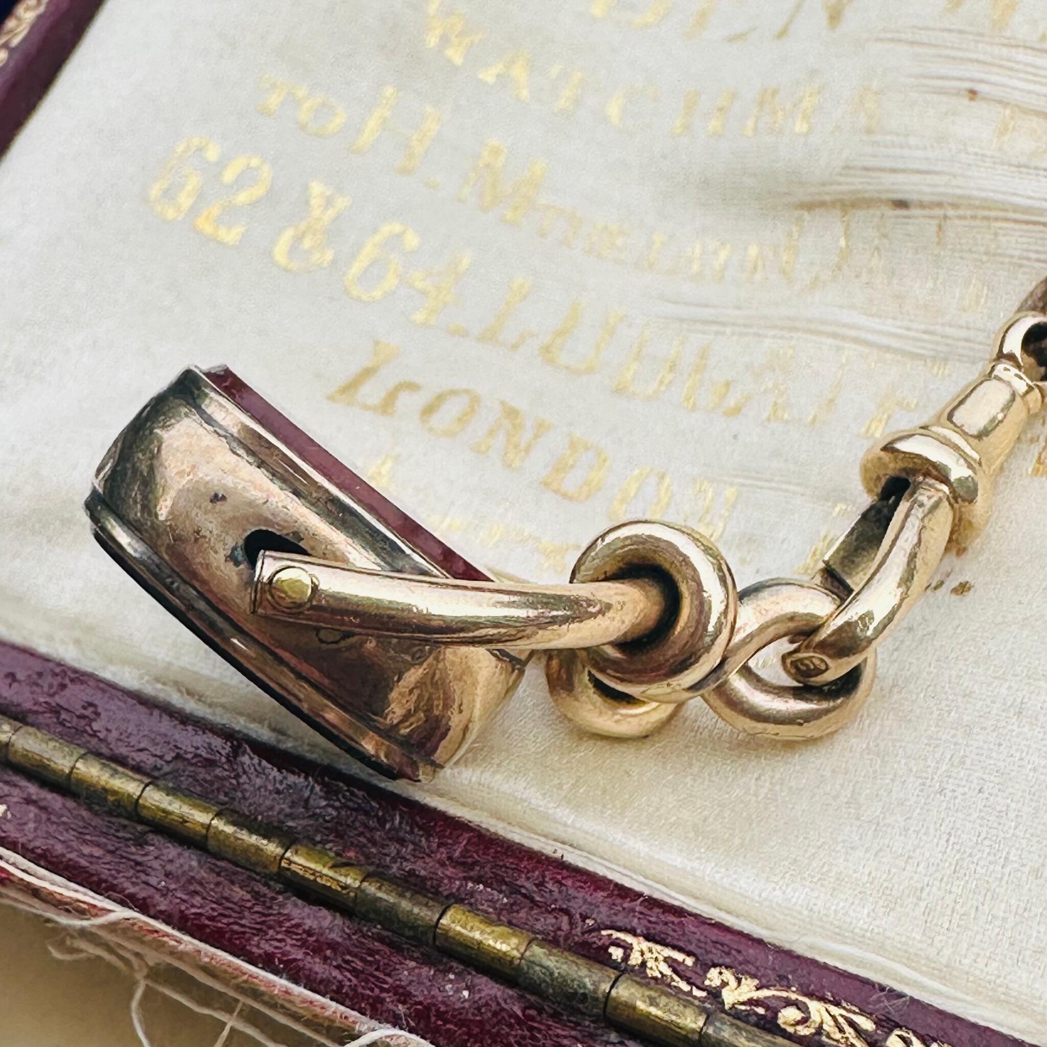 side view of Antique Victorian 9ct Gold Bloodstone & Carnelian Swivel Fob displayed on antique box