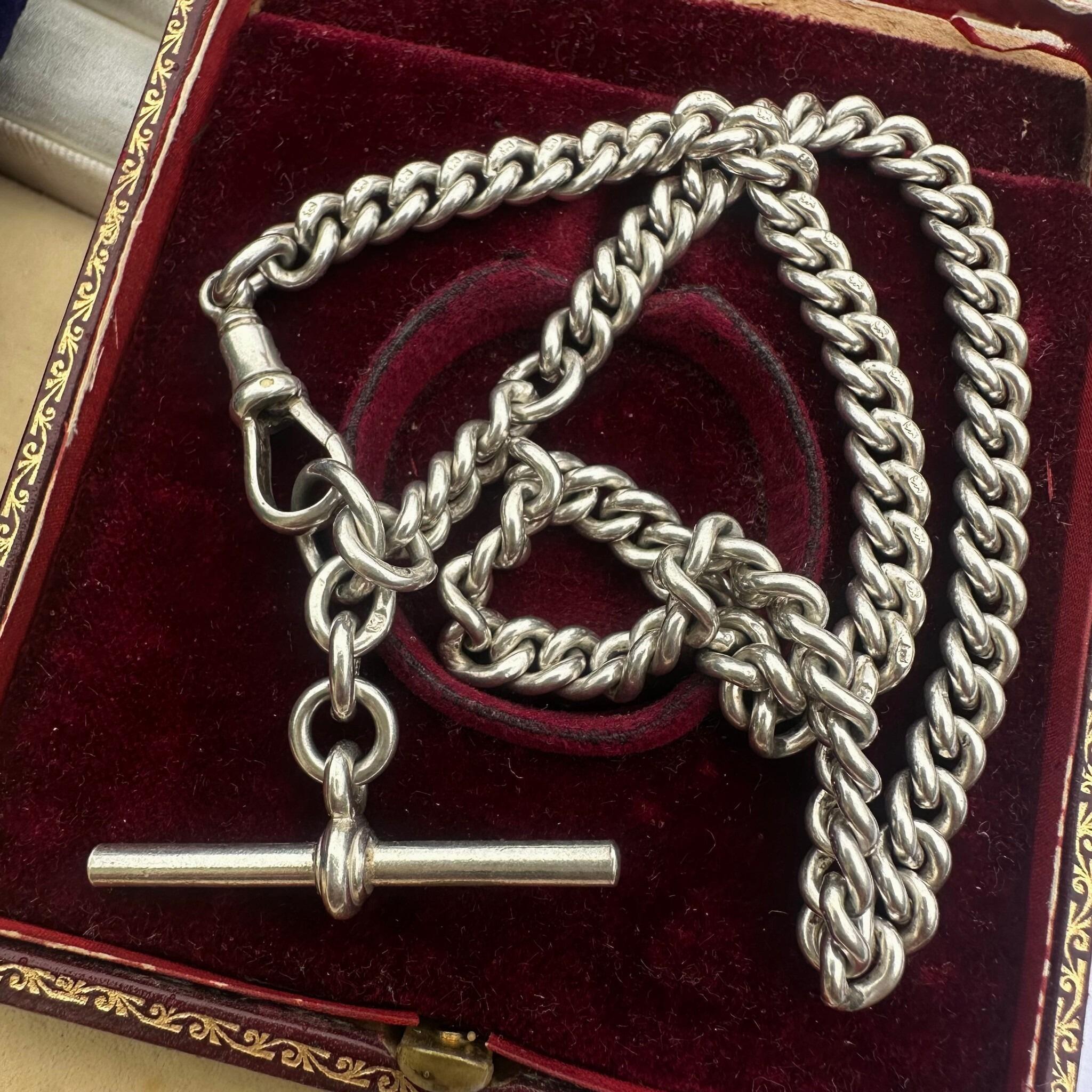 Antique Edwardian Sterling Silver Albert Chain, T Bar & Dog Clip displayed on red velvet