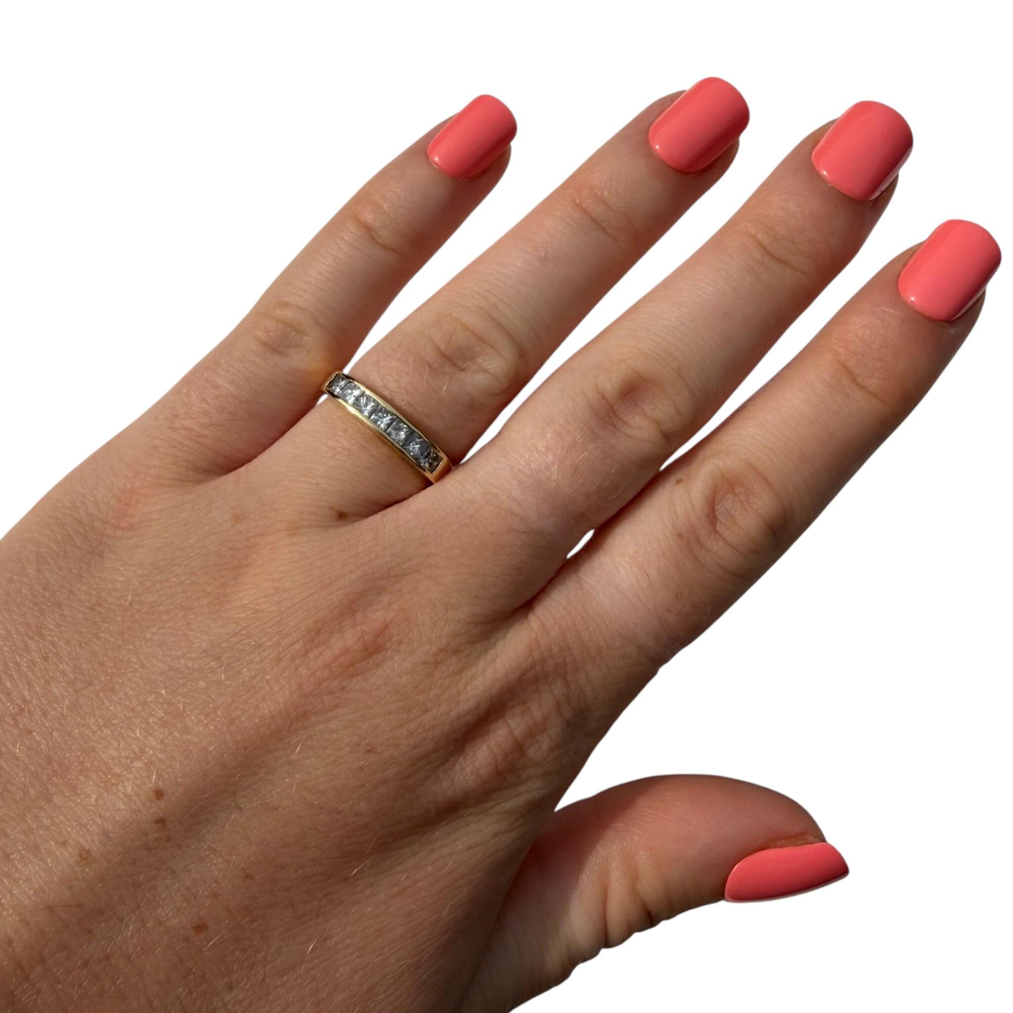 18k Yellow Gold Princess Cut Diamond Half Eternity Ring worn on models hand with white background