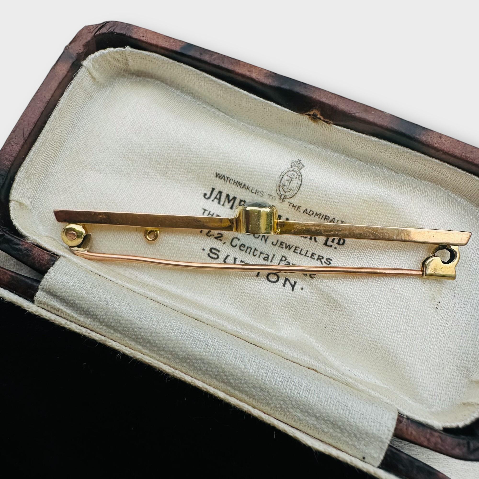side view, elegant Edwardian aquamarine bar brooch features a stunning 7x5mm oval aquamarine, mounted securely in a classic collet setting in antique box.