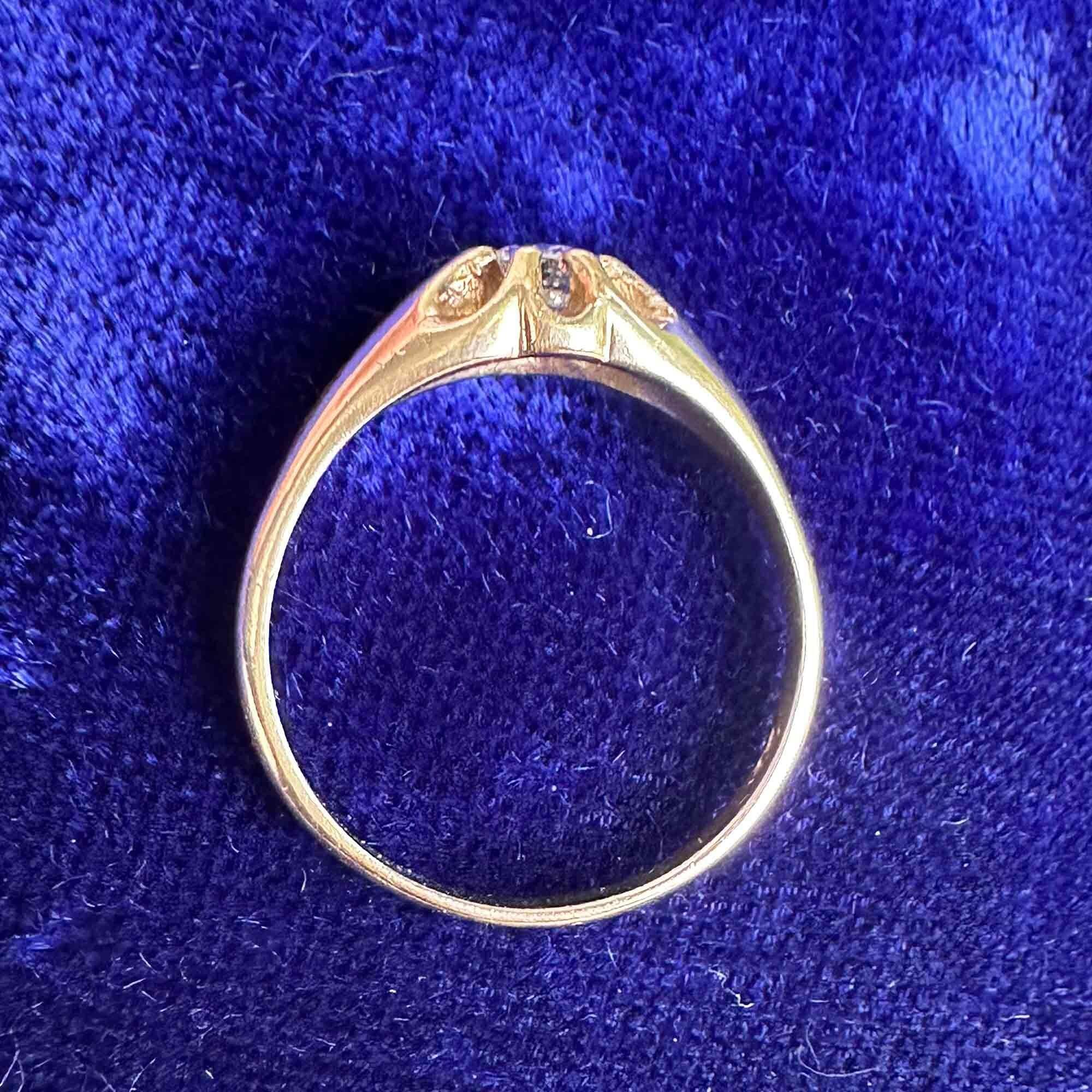 birds eye view of gents gold diamond solitaire gypsy ring on blue velvet pad