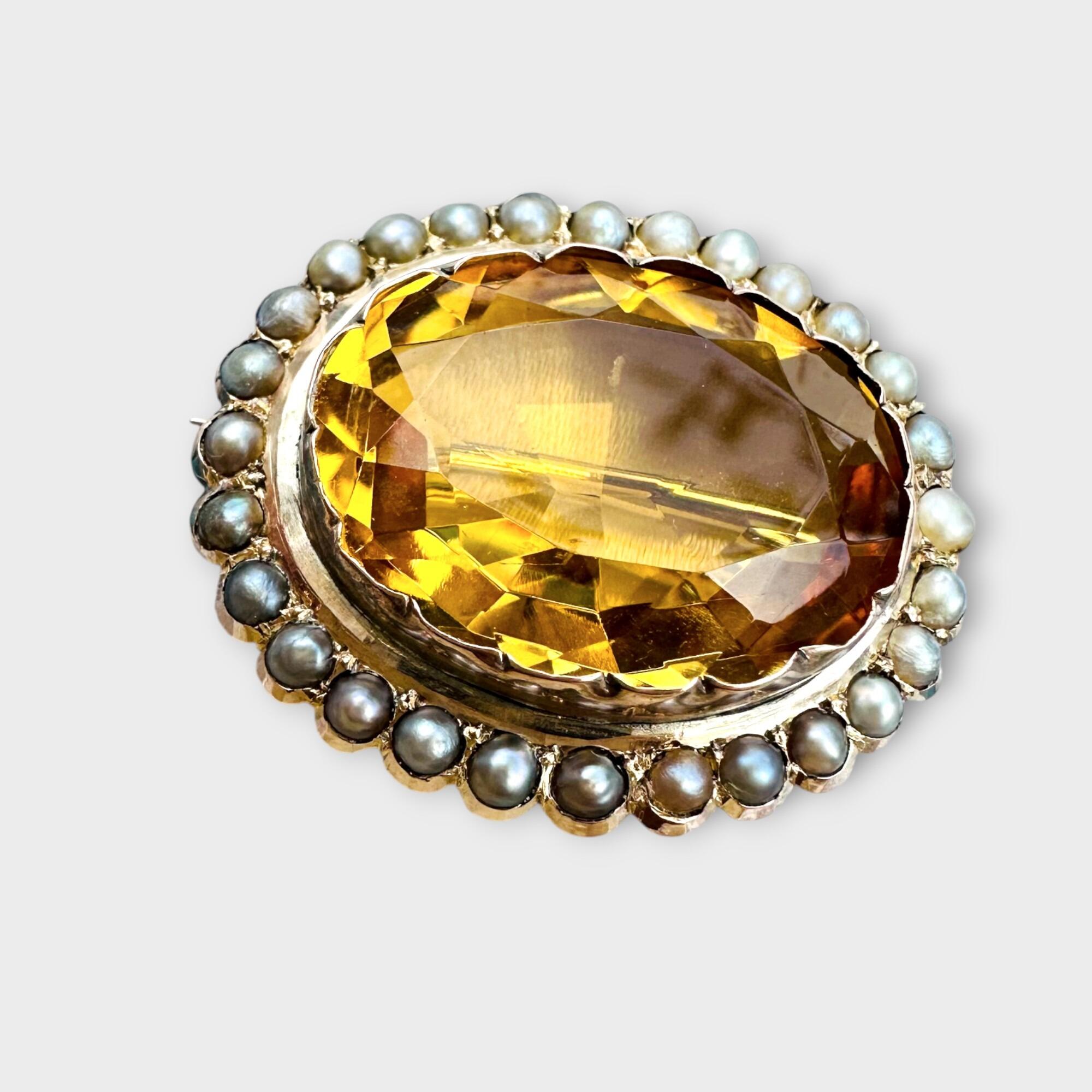 front view of Victorian citrine and pearl brooch in 9k rose gold, grey background.