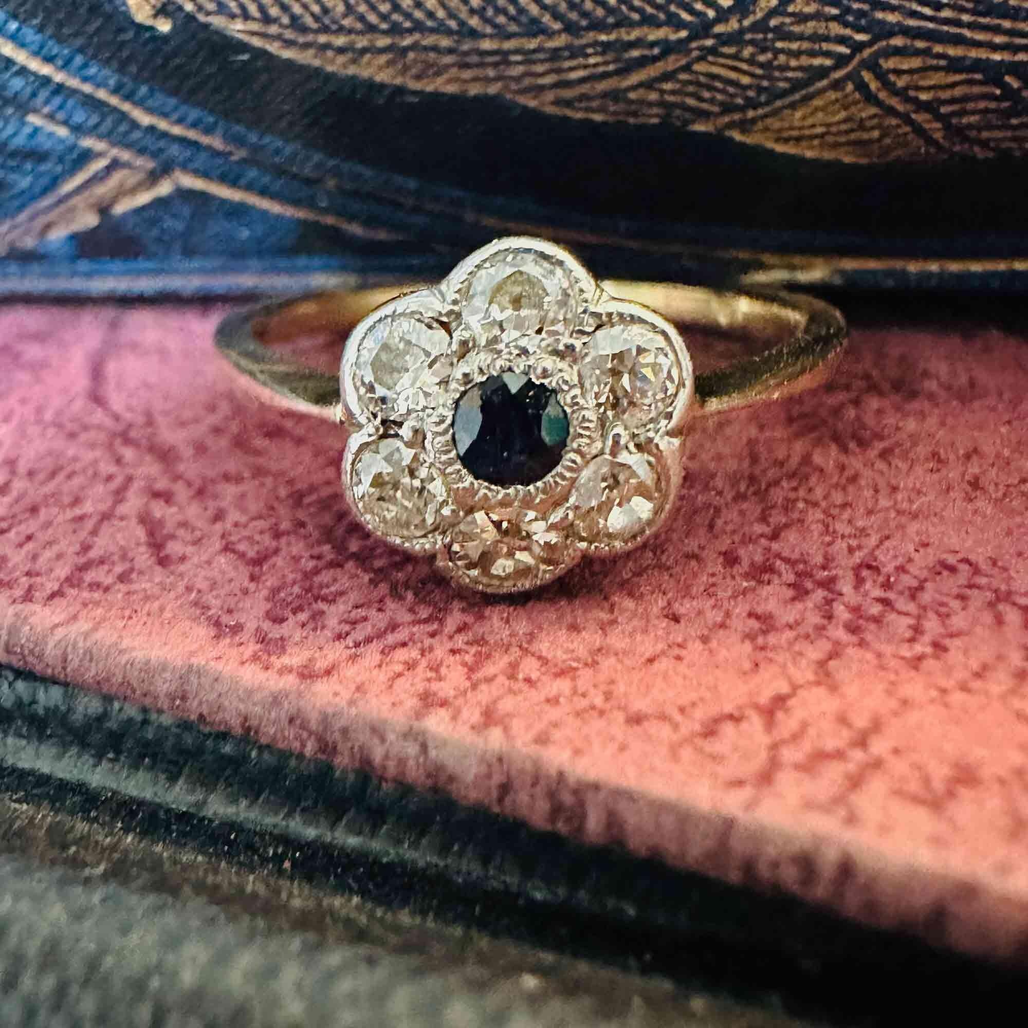 Art Deco 18k gold Sapphire and diamond cluster daisy ring on antique boxes.