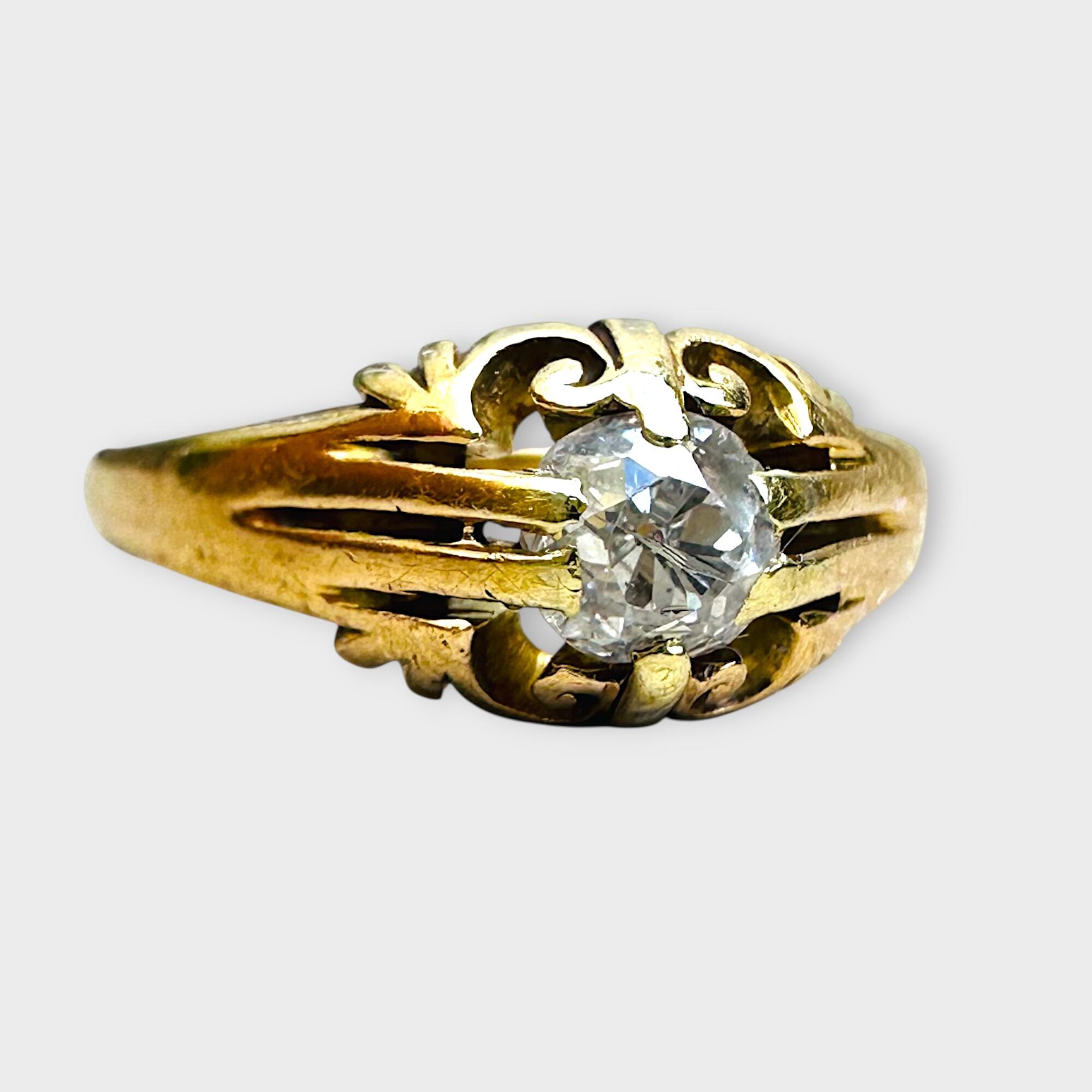 Side view, Antique 18k yellow gold old cut diamond gypsy ring on grey background.