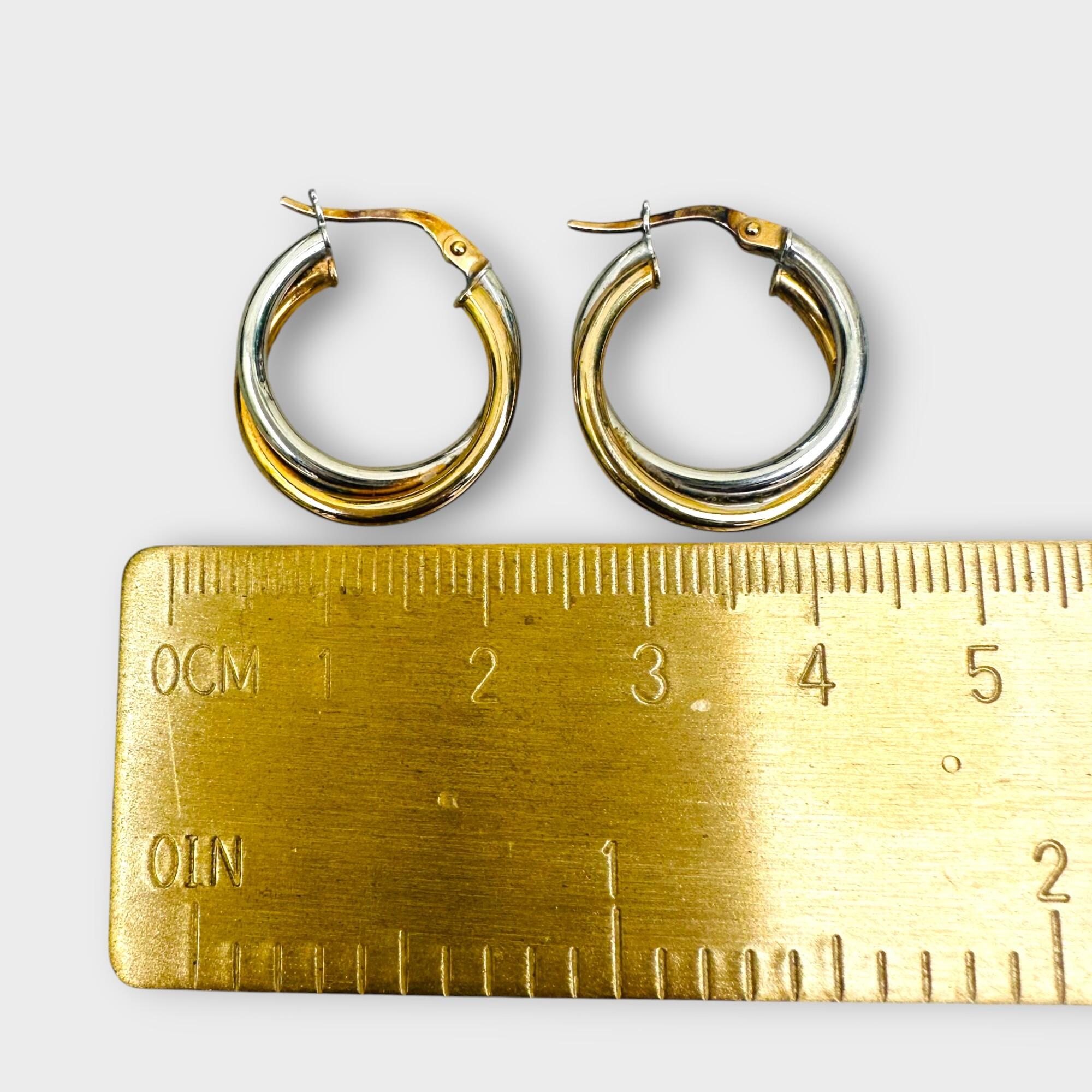 Italian bi-colour 9ct gold hoop earrings on grey background next to ruler.