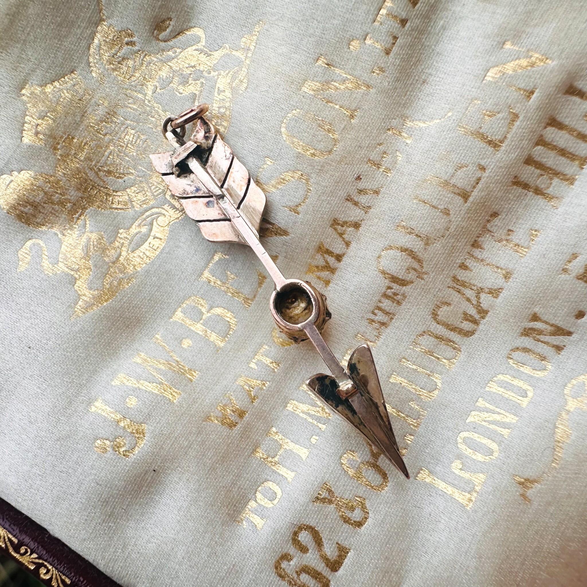 rear view Victorian Rose Cut Diamond & Pearl Cupid’s Arrow Pendant displayed on antique box