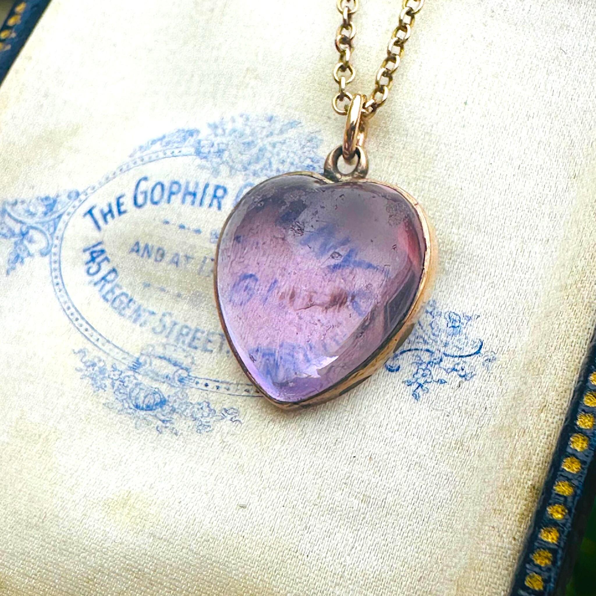 Rose de France Amethyst Heart Pendant & Gold rolo link chain displayed on antique box
