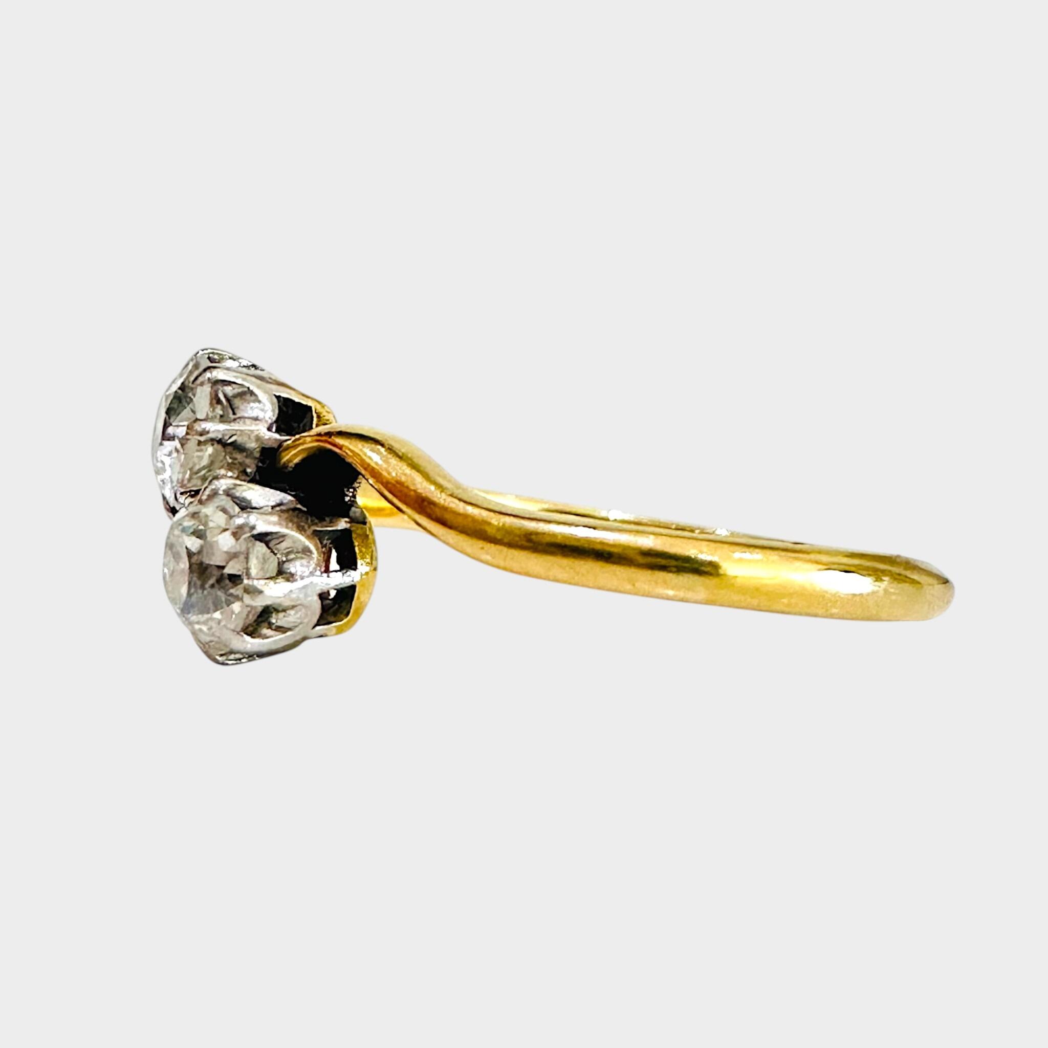 side view of 18ct Gold & Diamond Toi et Moi Ring with grey background
