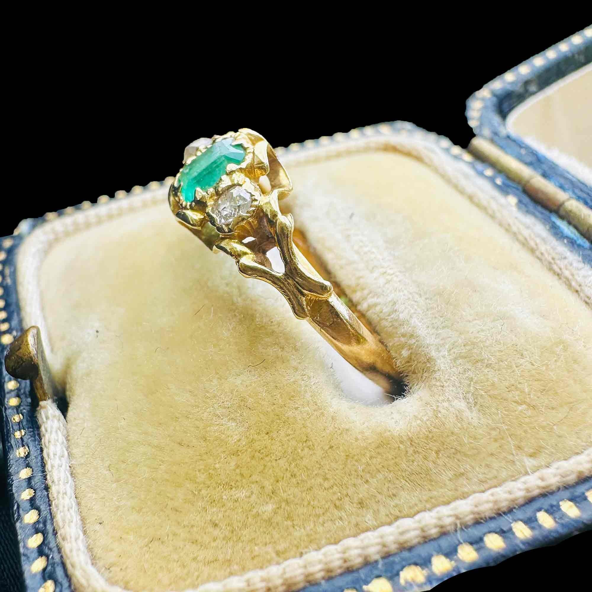 side view of Emerald & Diamond Three Stone Victorian Ring displayed on antique box