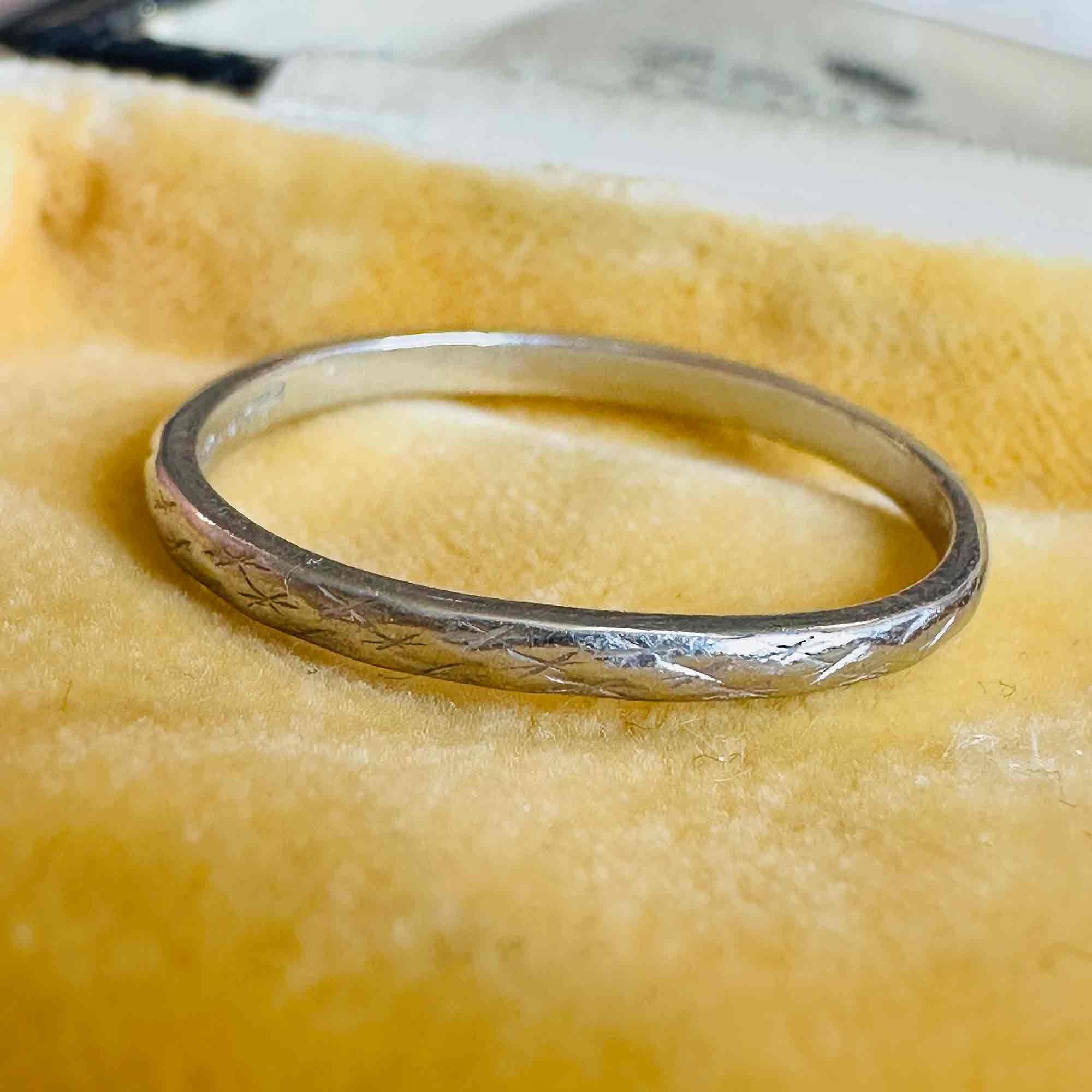 Art Deco Hand Engraved Platinum Wedding Band displayed on antique box