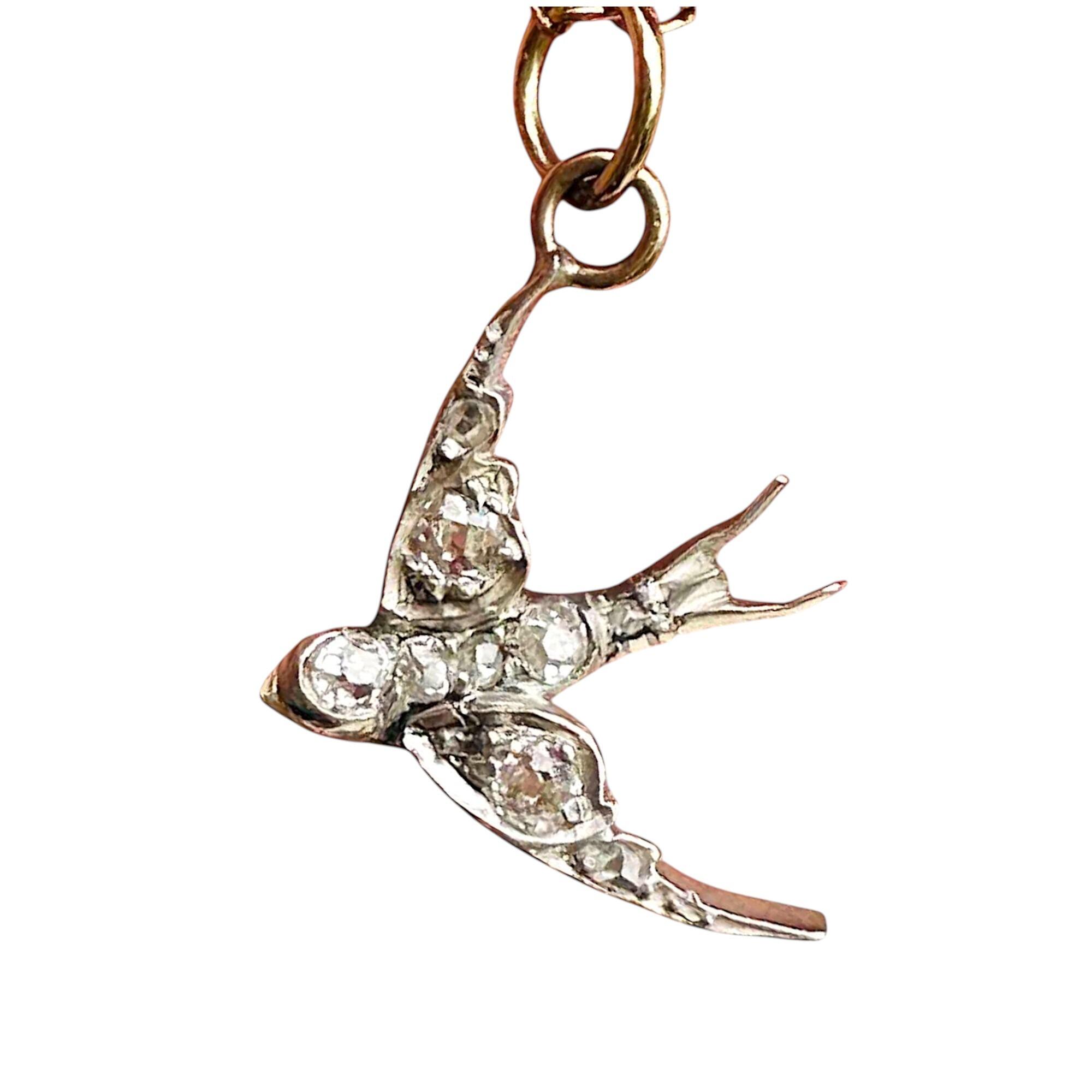 Antique Diamond swallow pendant on white background.