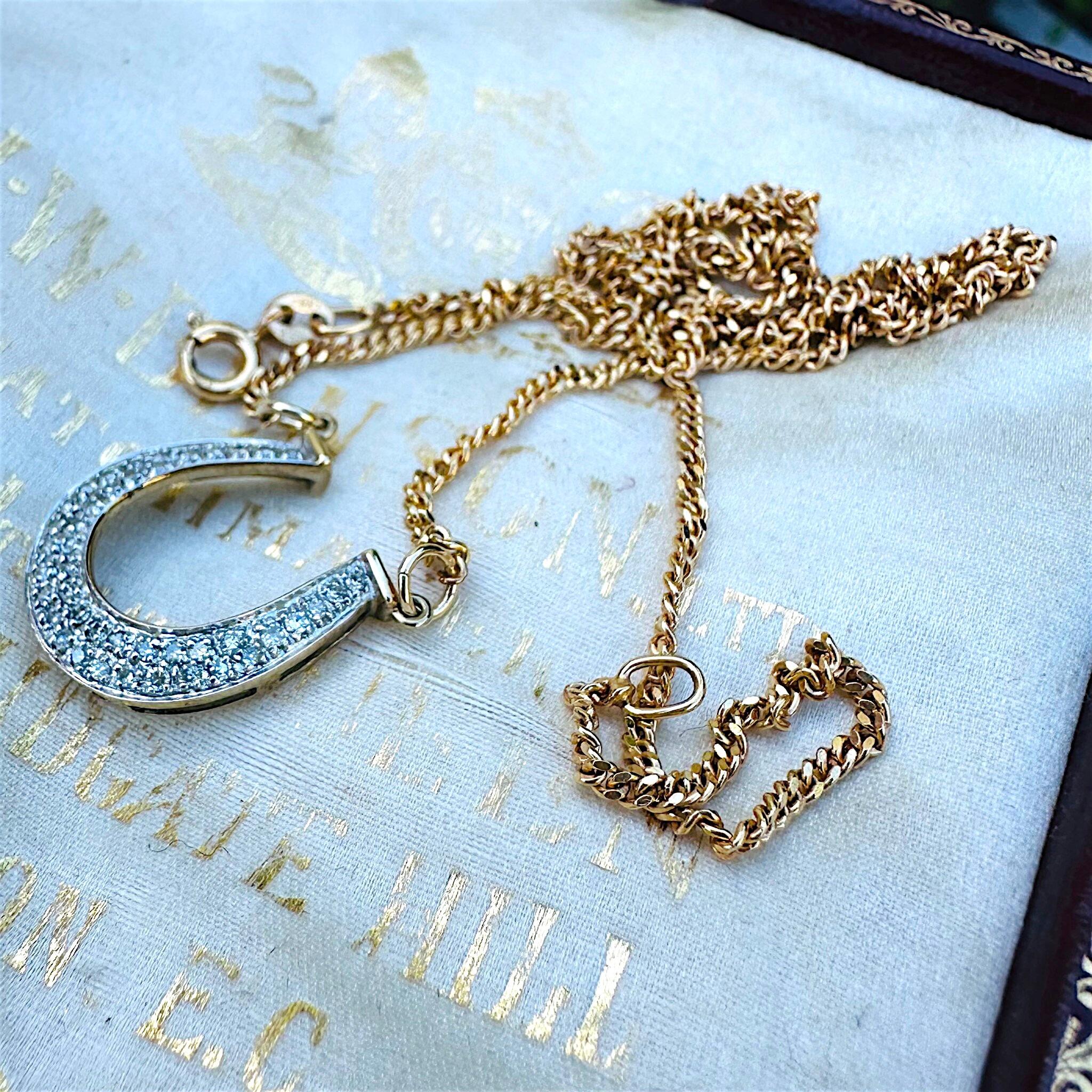 side profile of Vintage Diamond Horseshoe Necklace displayed on antique box