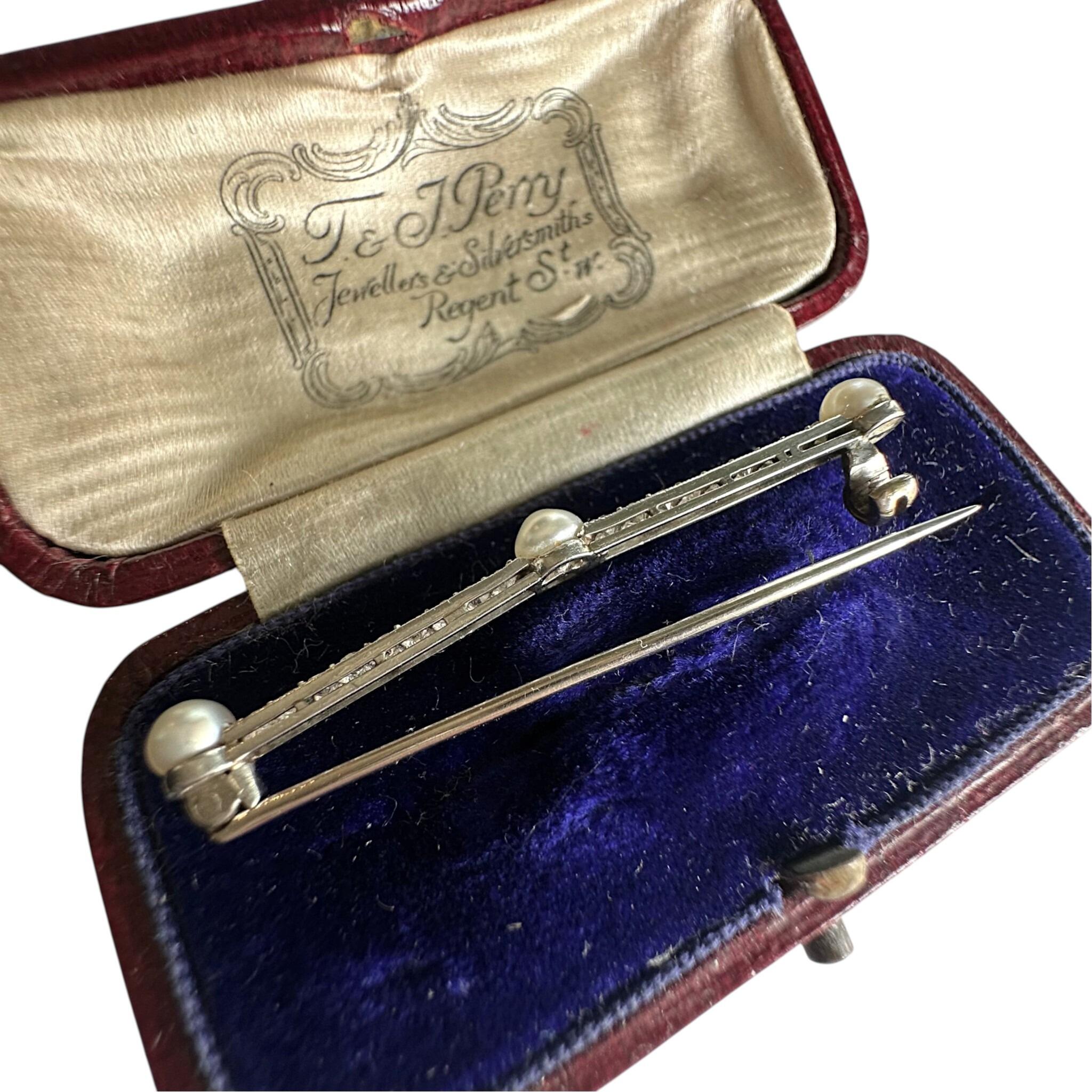 side profile of Antique Edwardian Platinum Diamond & Pearl Bar Brooch displayed in original box with wite background