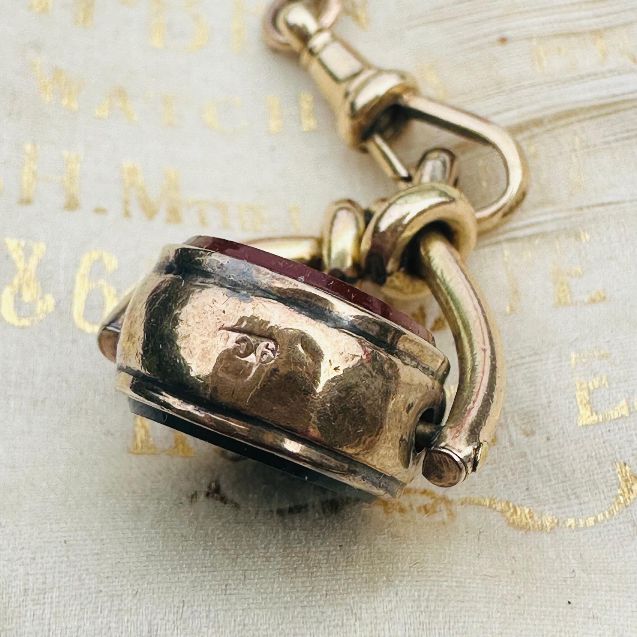 side view of Antique Victorian 9ct Gold Bloodstone & Carnelian Swivel Fob displayed on antique box