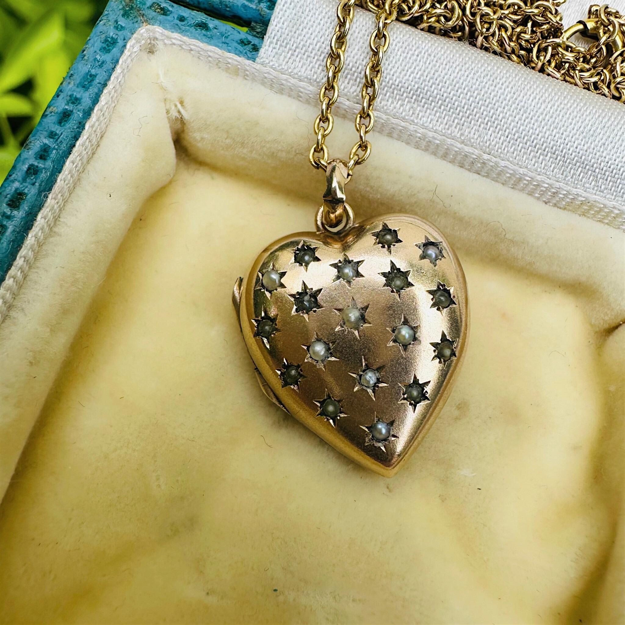 Vintage Gold Pearl Star Set Puffy Heart Locket displayed on antique box