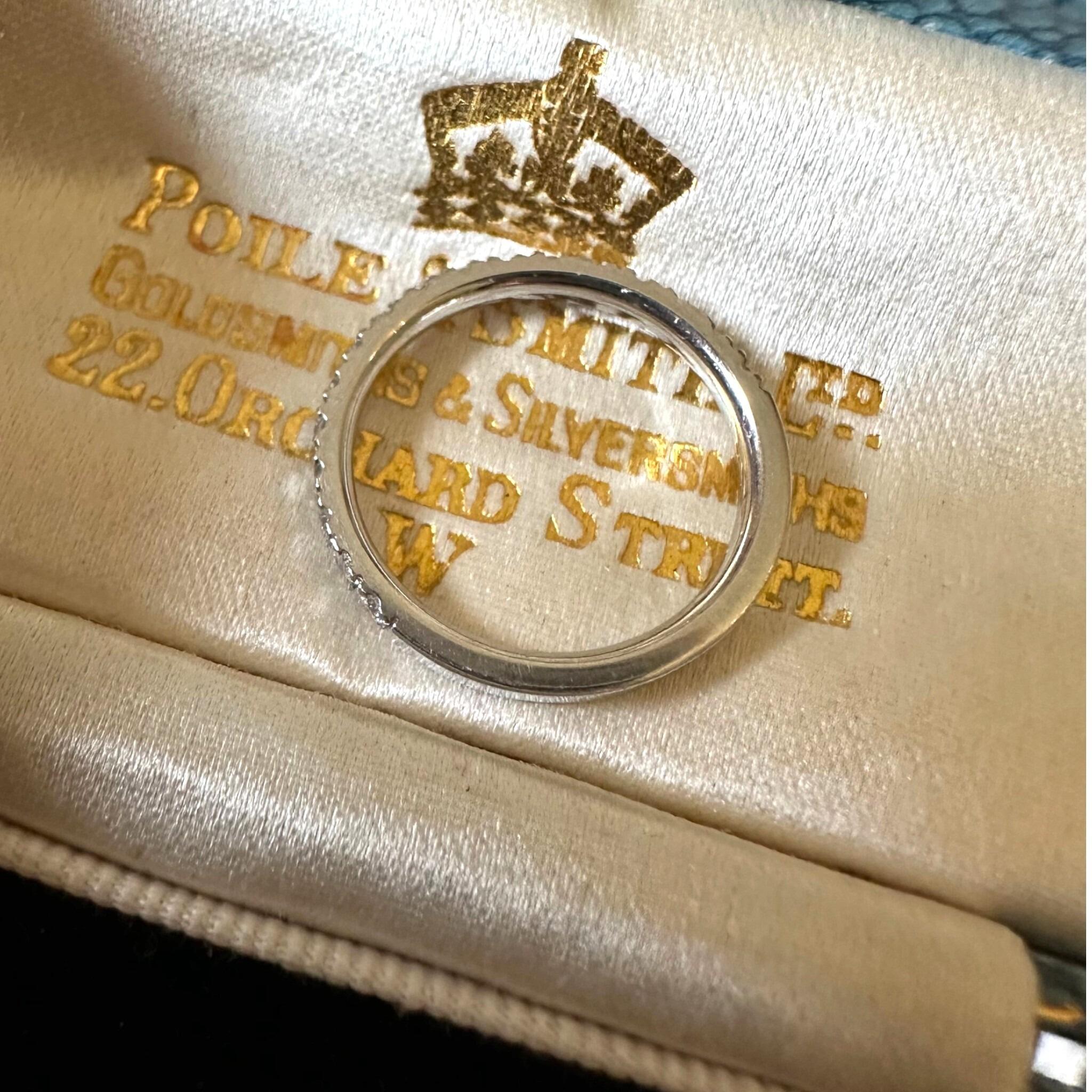 Vintage Platinum & Diamond Band Ring laying on an antique box