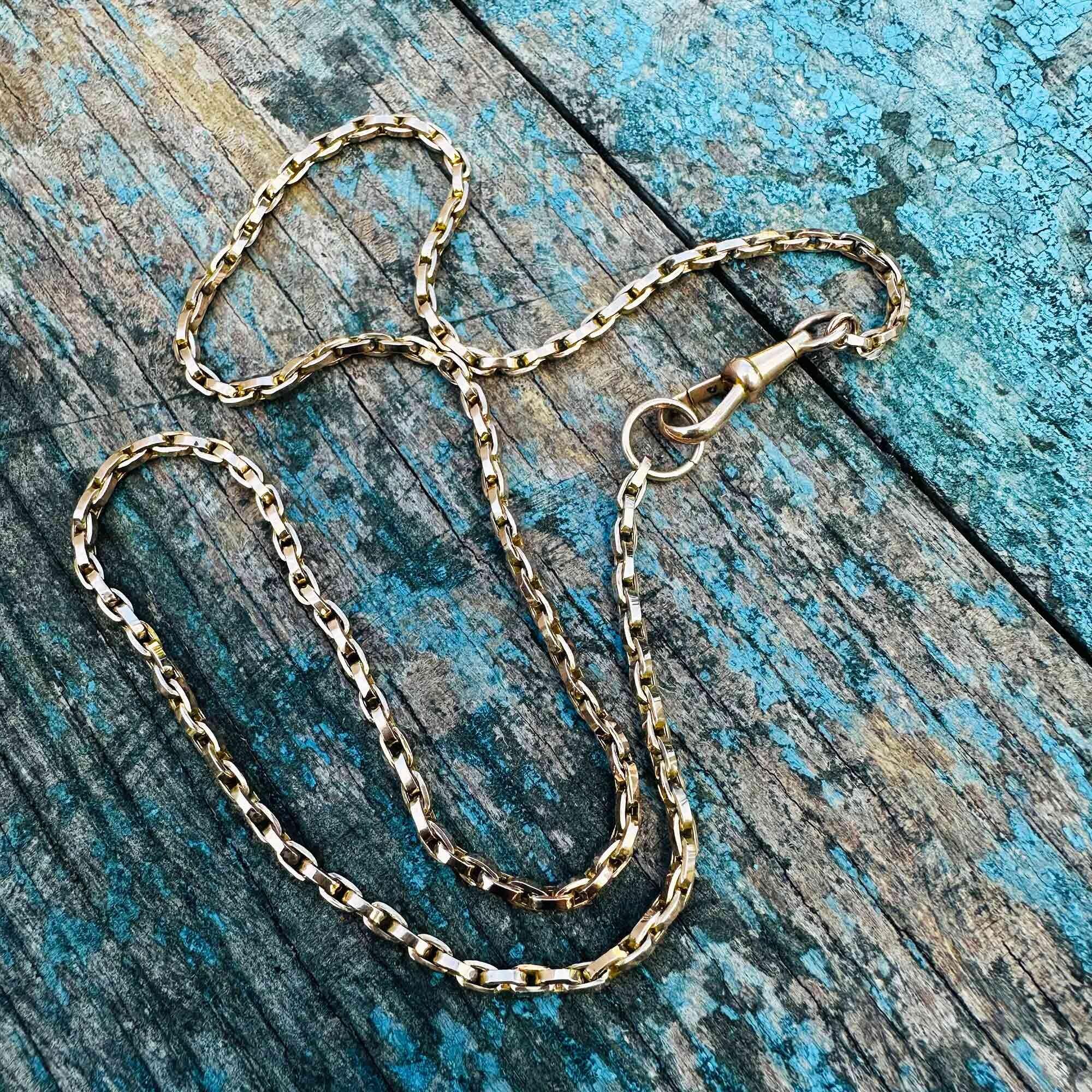 Victorian 9k rose gold bike chain necklace with dog clip clasp – on green background