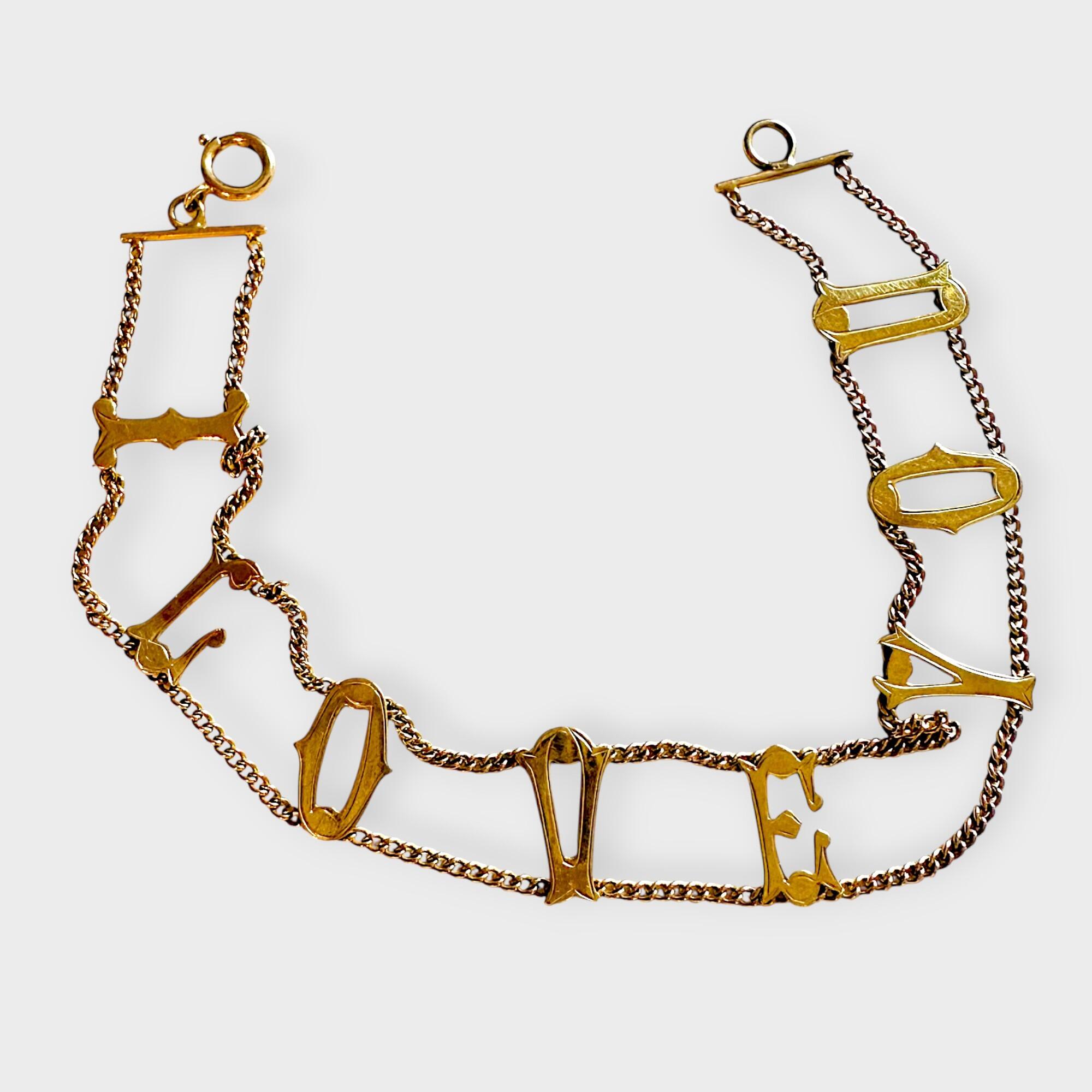 Vintage 9ct gold bracelet with "I Love You" links with grey background.
