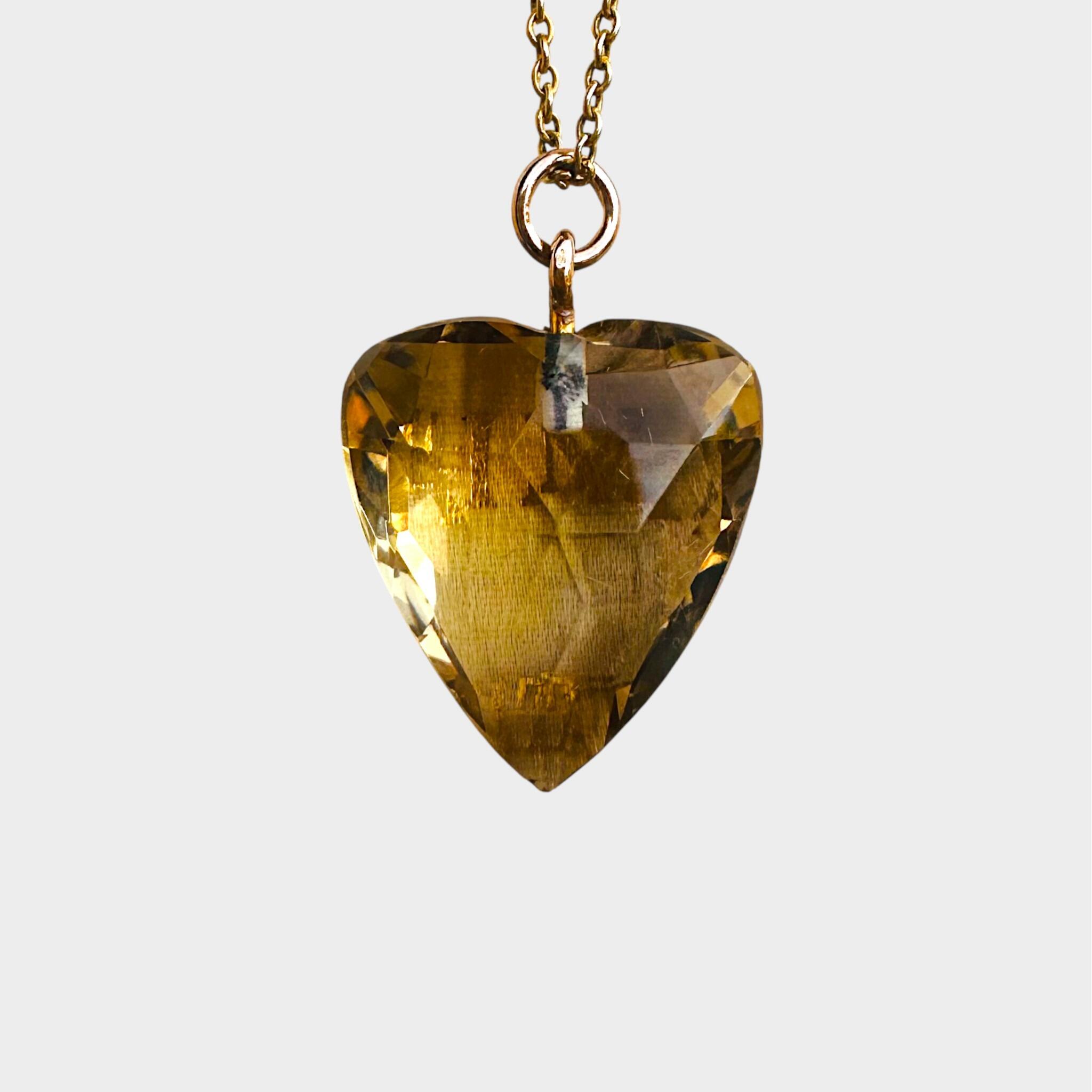 Gold & Citrine heart pendant with grey background