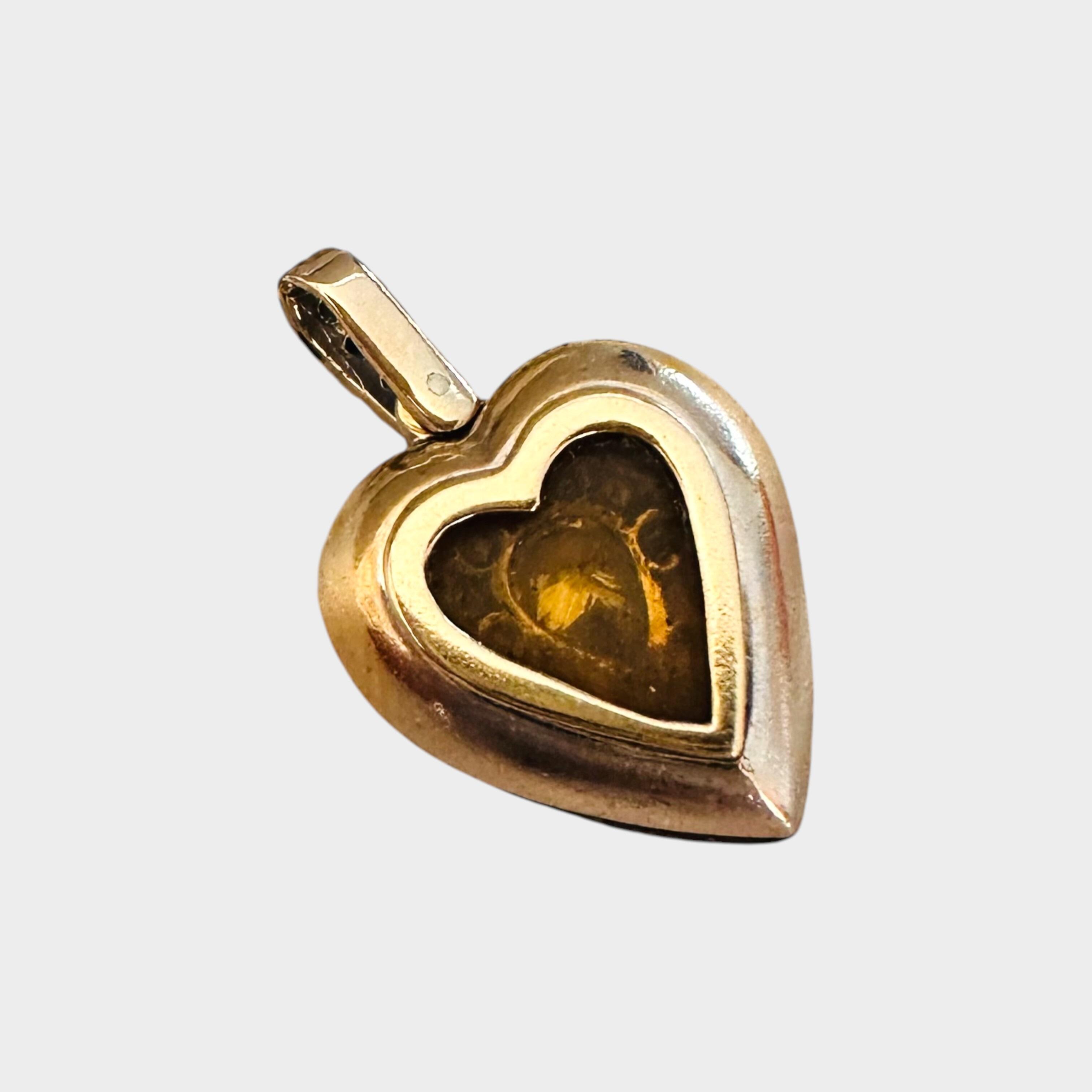 rear view of Diamond Heart Locket Pendant with Pear-Shaped Center, grey background
