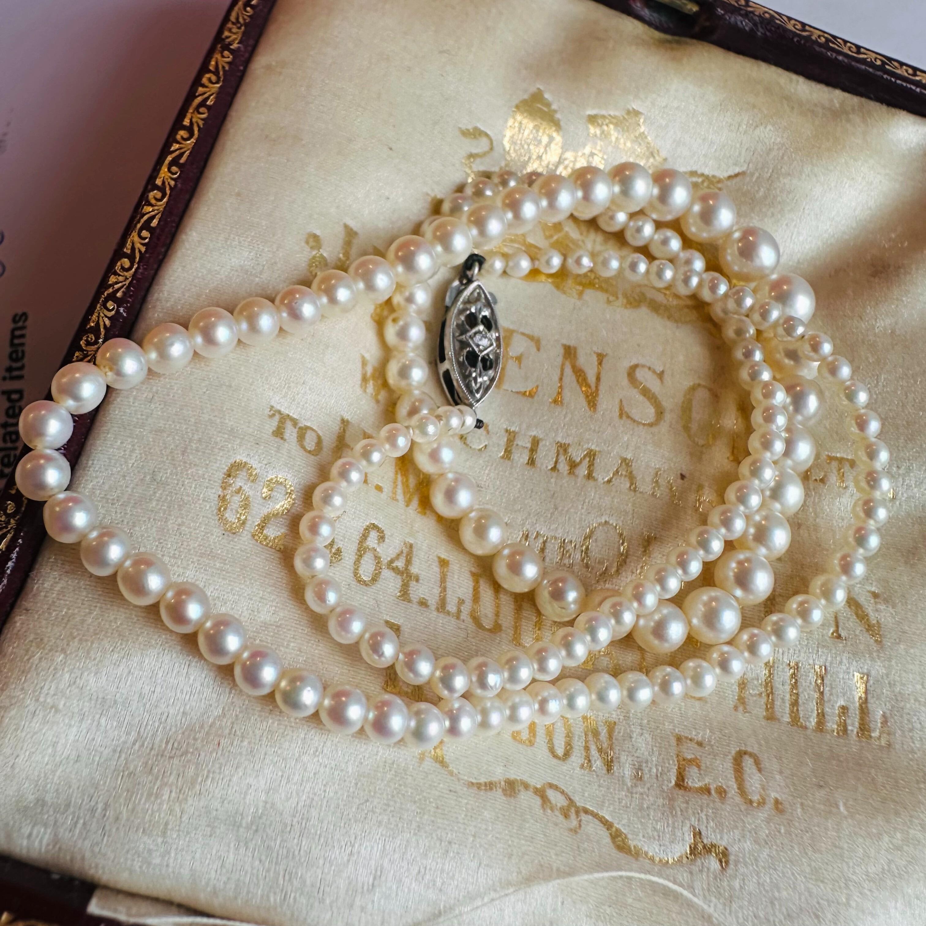 White Gold & Diamond, Saltwater Cultured Pearl Necklace displayed on antique box