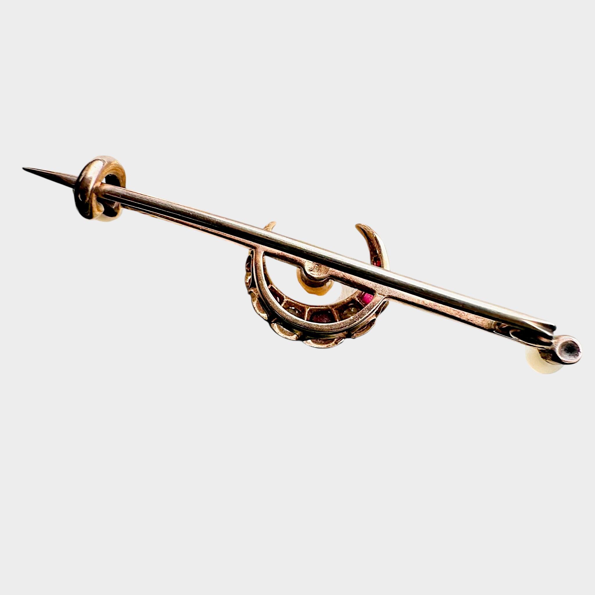 rear view of 15ct Gold Diamond, Ruby & Pearl Crescent Moon Brooch with grey background