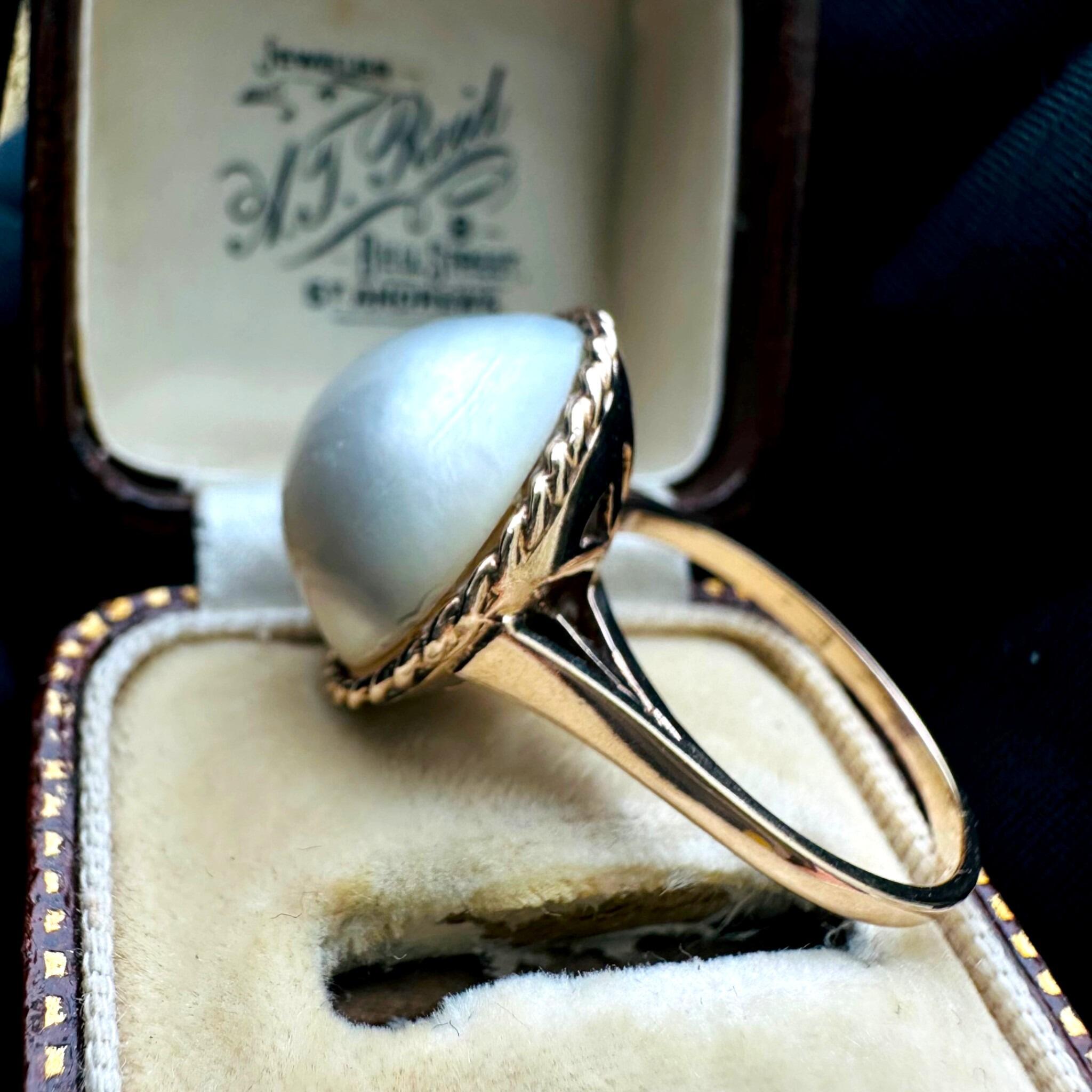 side profile of Vintage 9k Gold Mabe Pearl Cocktail Ring displayed on antique box