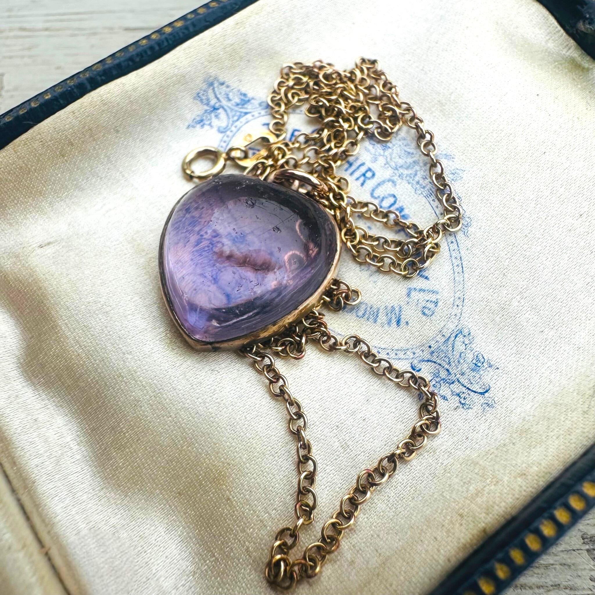 Rose de France Amethyst Heart Pendant & Gold rolo link chain displayed on antique box