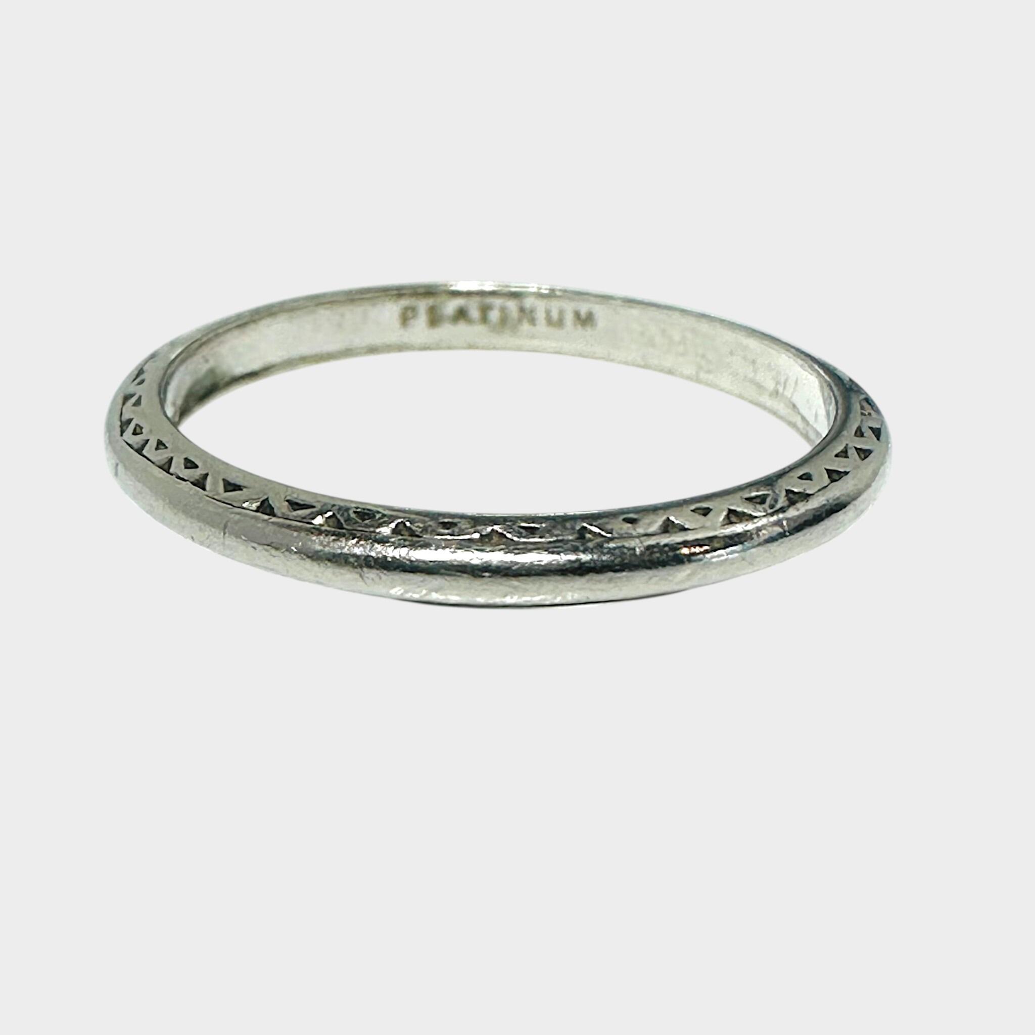 Art Deco Platinum Wedding Band Ring on grey background